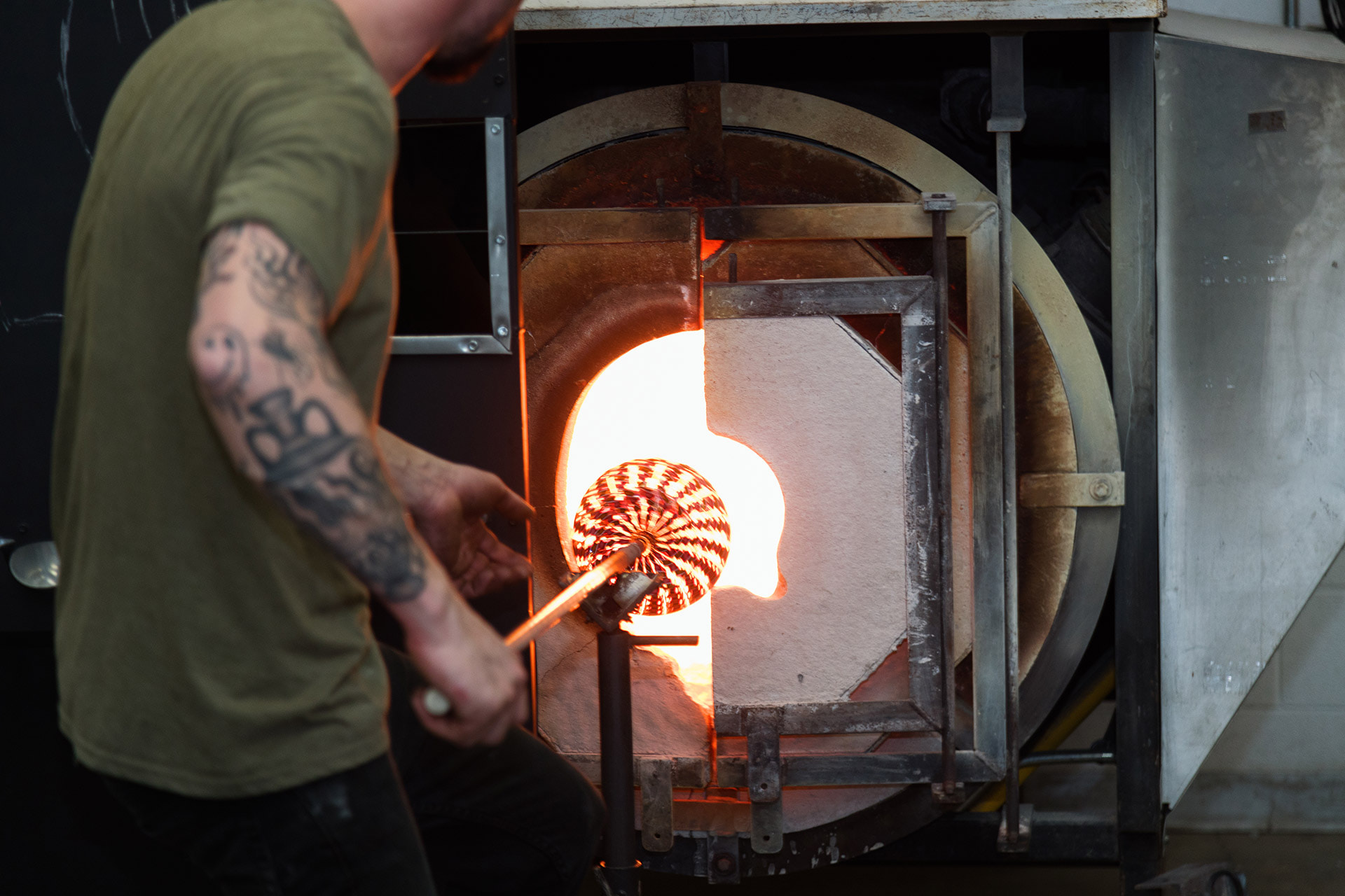A person putting glass in a kiln