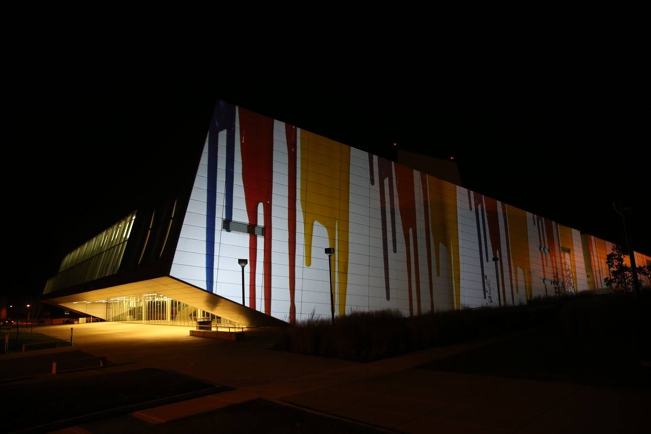 Wolfe Center with paint dripping projected onto the wall