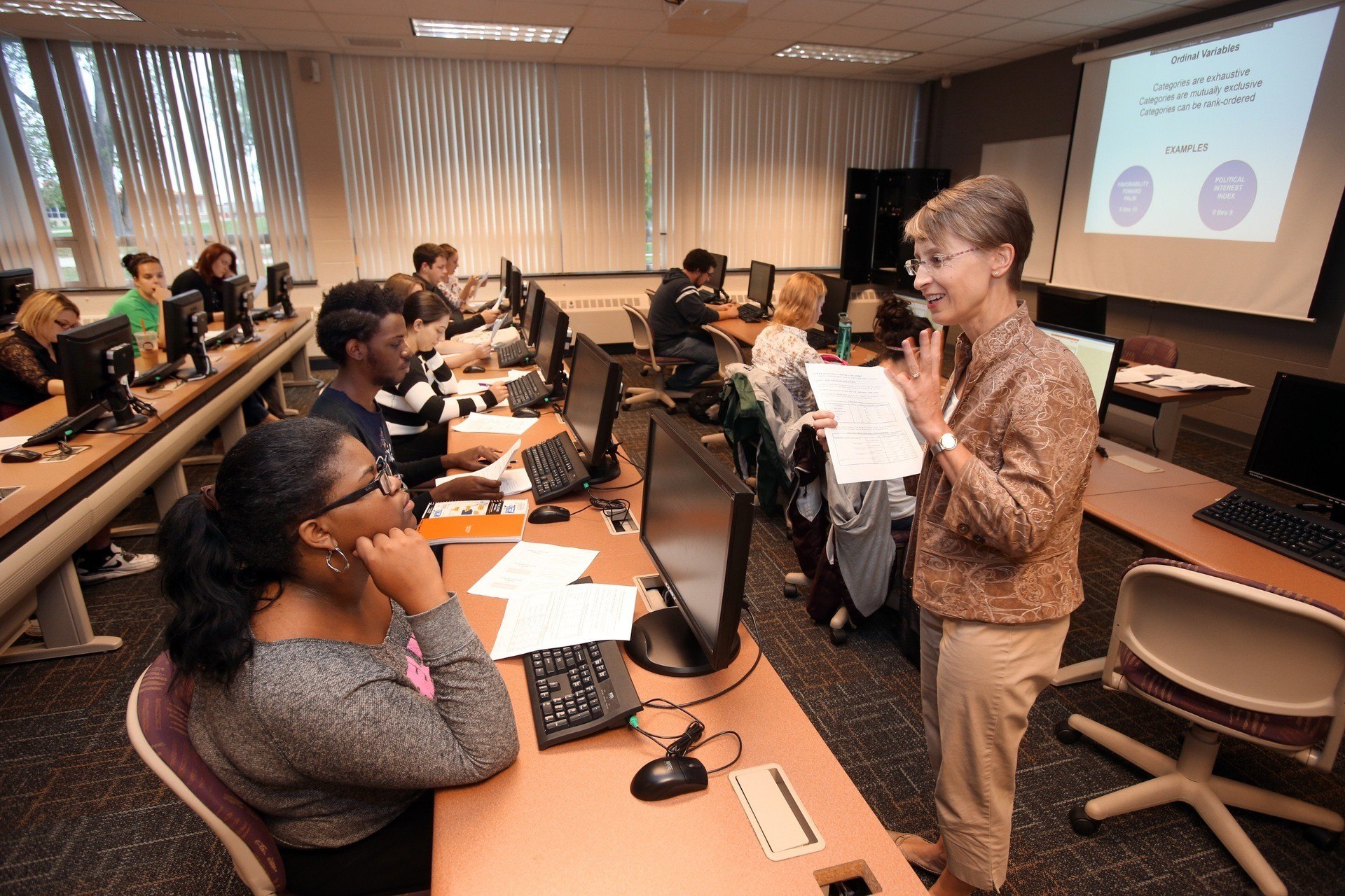 A teacher speaking to a class full of students