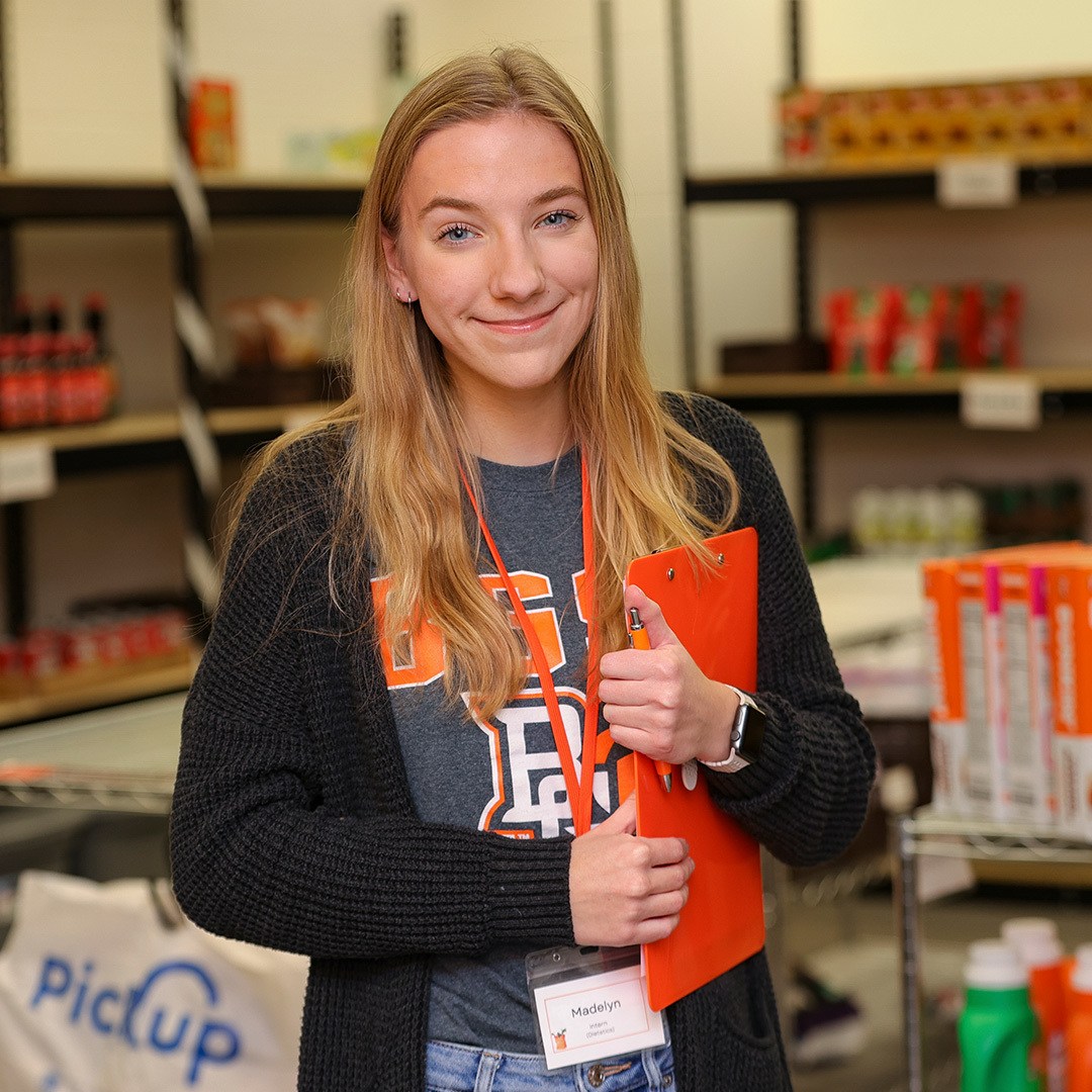 Student smiling in a pantry