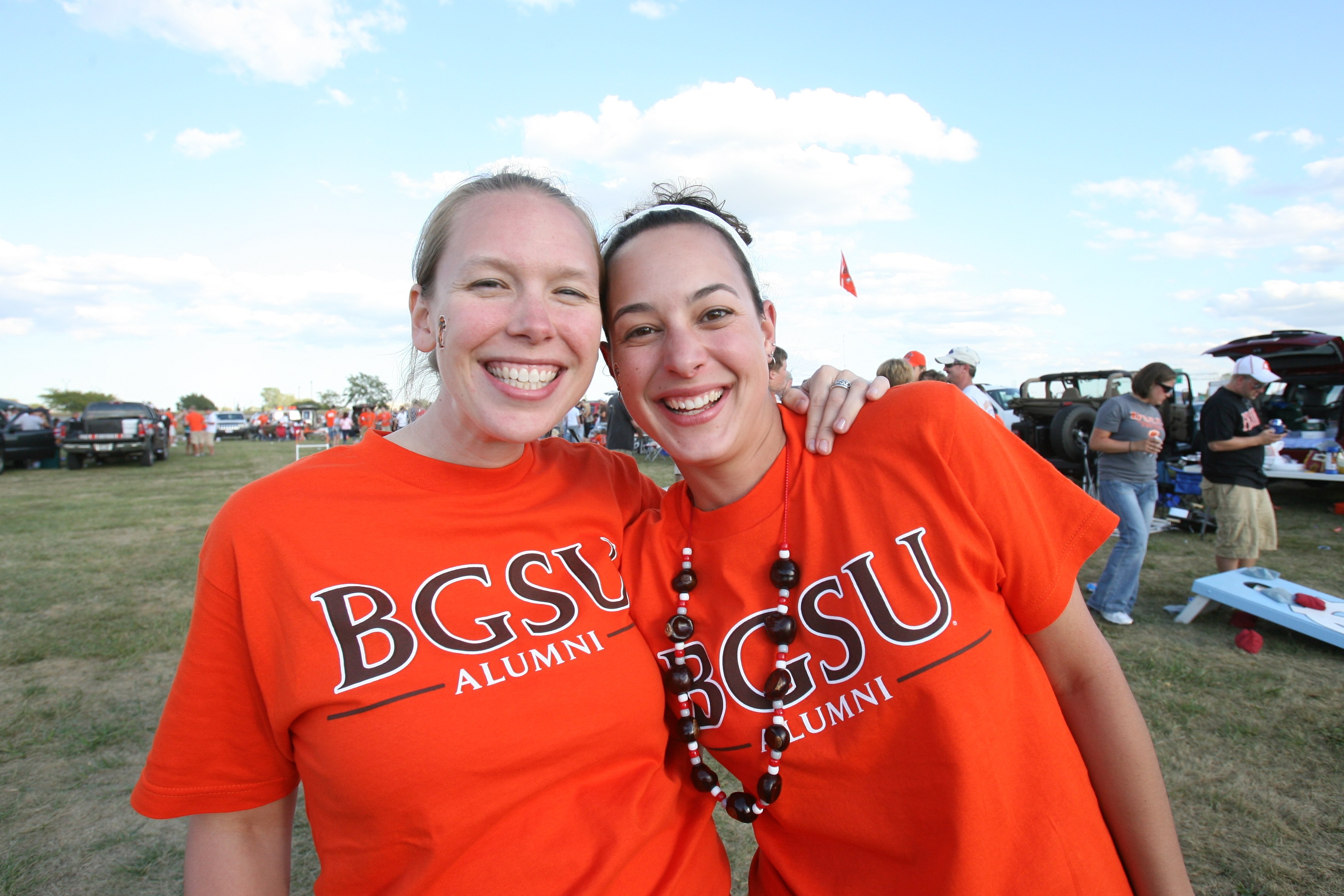 Two people smiling together and wearing BGSU Alumni shirts