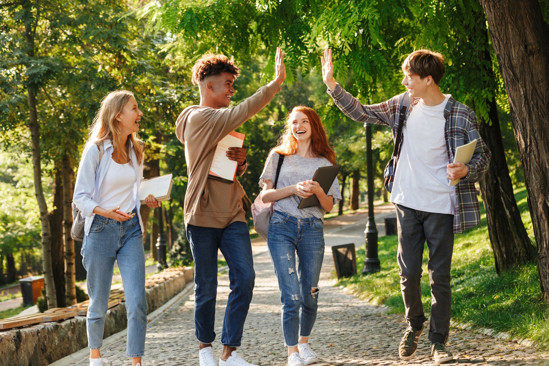 Group of laughing students walking at the campus