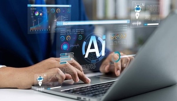 Decorative image of someone type at laptop with AI logo