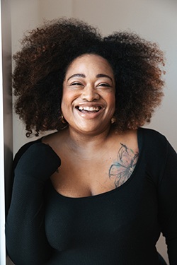 Exuberant Black woman smiles at camera