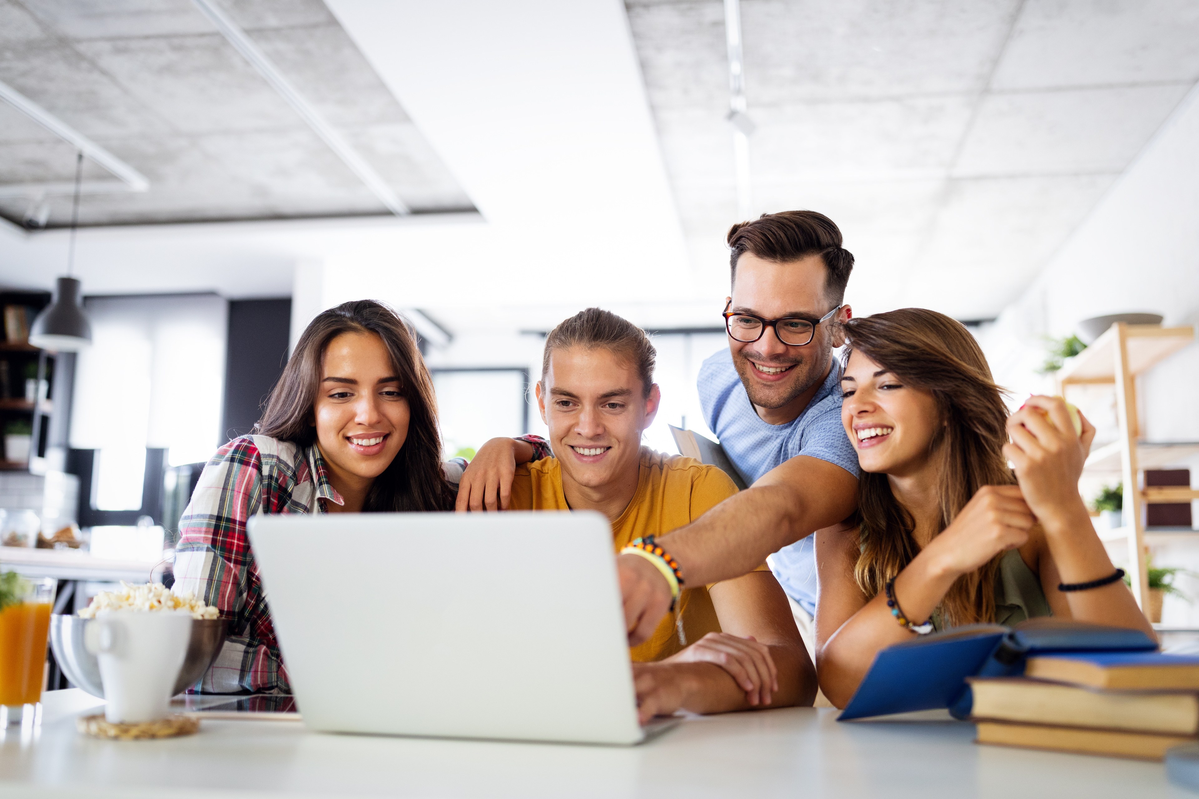 Four students looking at a laptop.