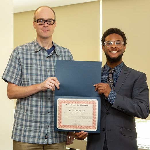Kyle Thompson (right) and Associate Professor Steve Demuth at McNair luncheon