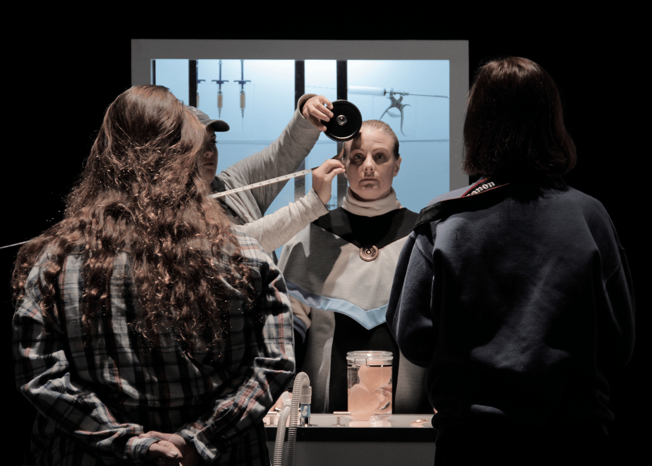 Three crew members set up a shot focused on one actor on a film shoot