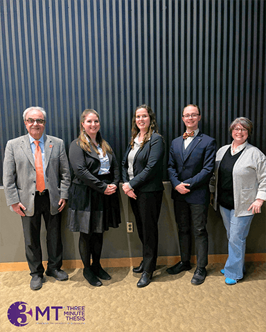 5 people standing for a full length picture.  On the far left Ali Eskandarian, Dean of the Graduate college. Next are the first place tied winners Erika Shultz and Lindsay Denecker.  2nd from the right is Josiah Leinbach, our 2nd place winner.  On the far right is Kristine Ketel the 3rd place winner.