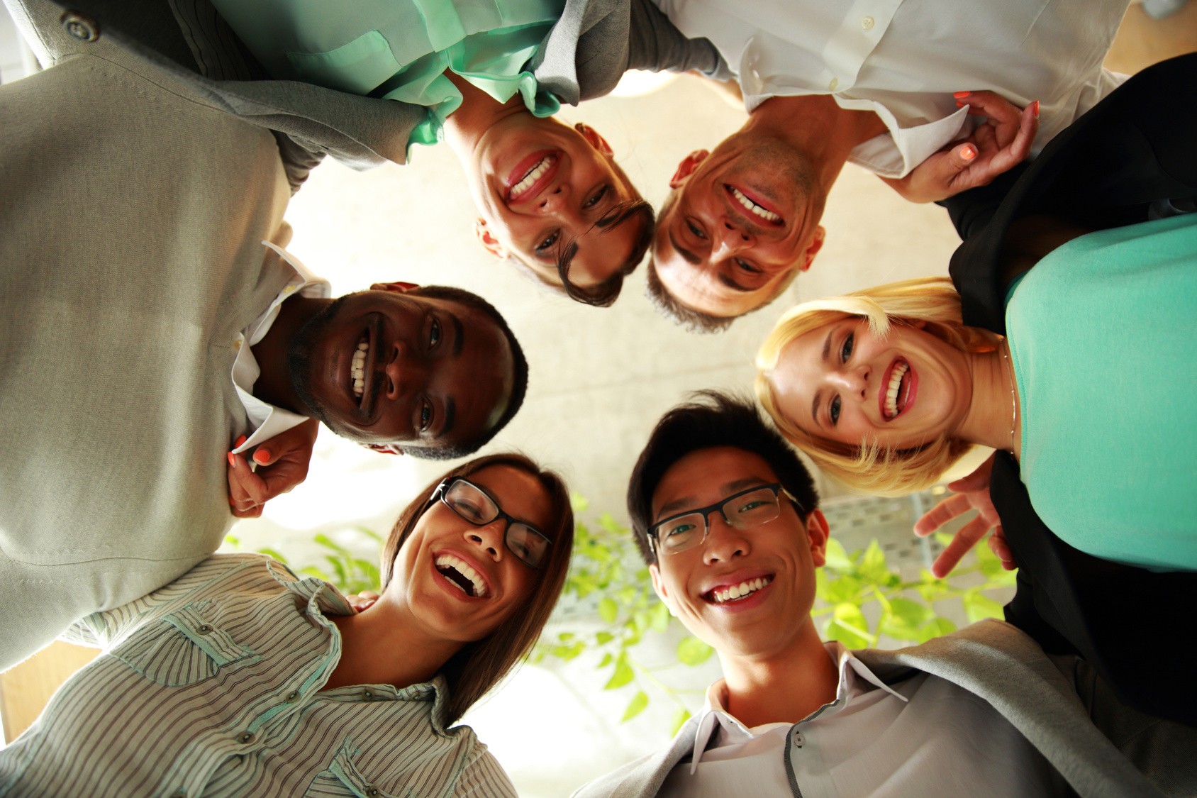 Happy business people with their heads together