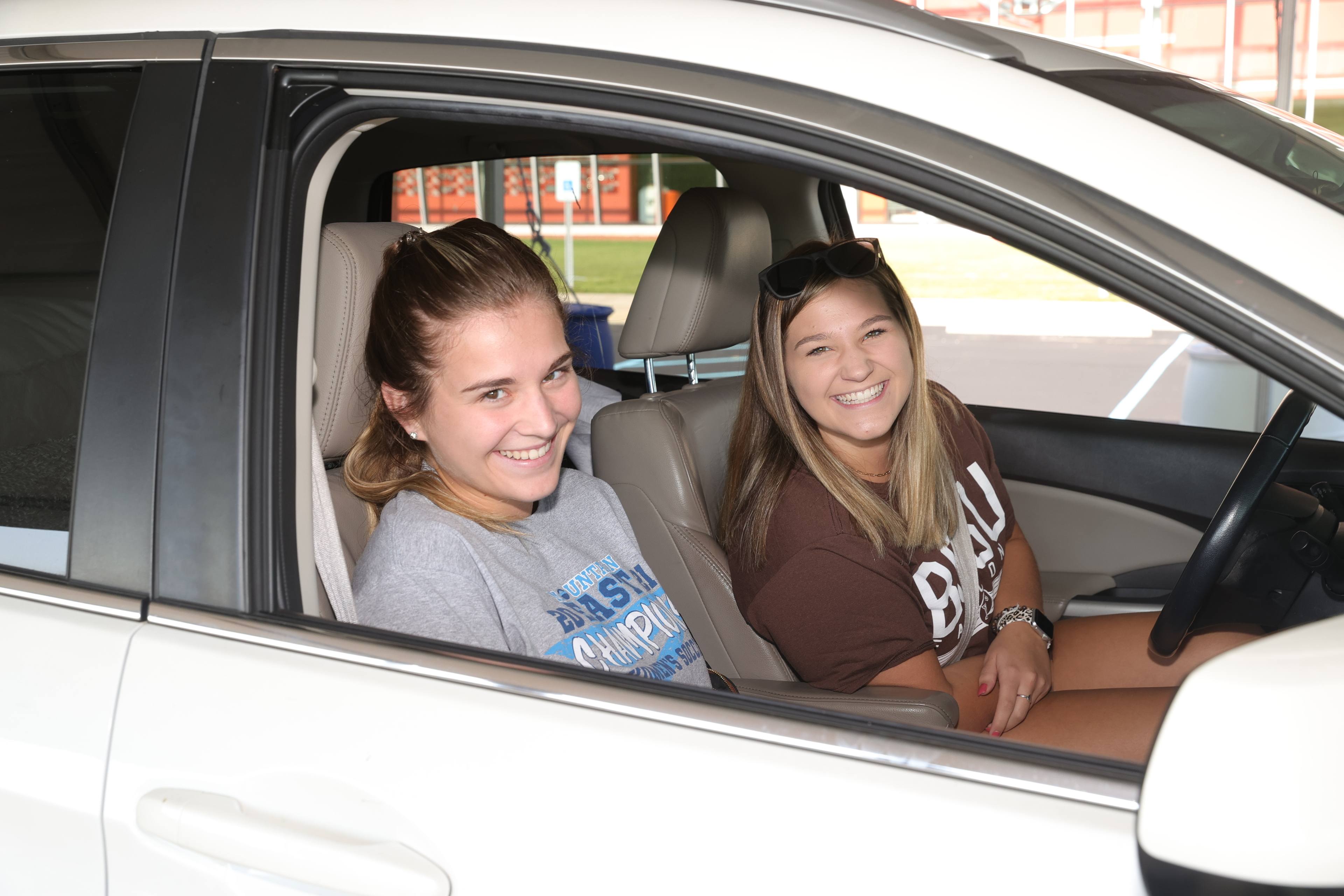 two students in a car
