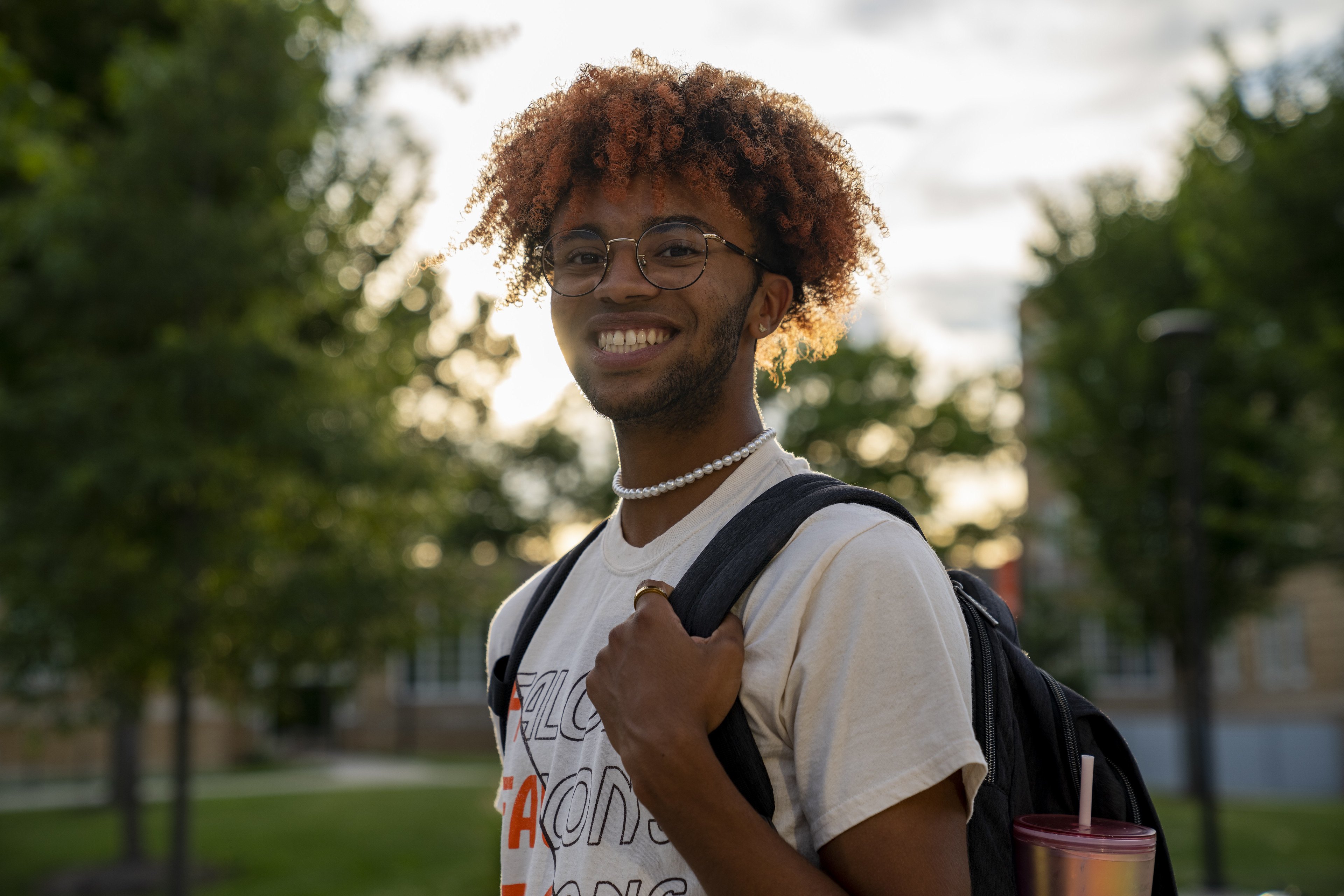 person smiling on campus outside