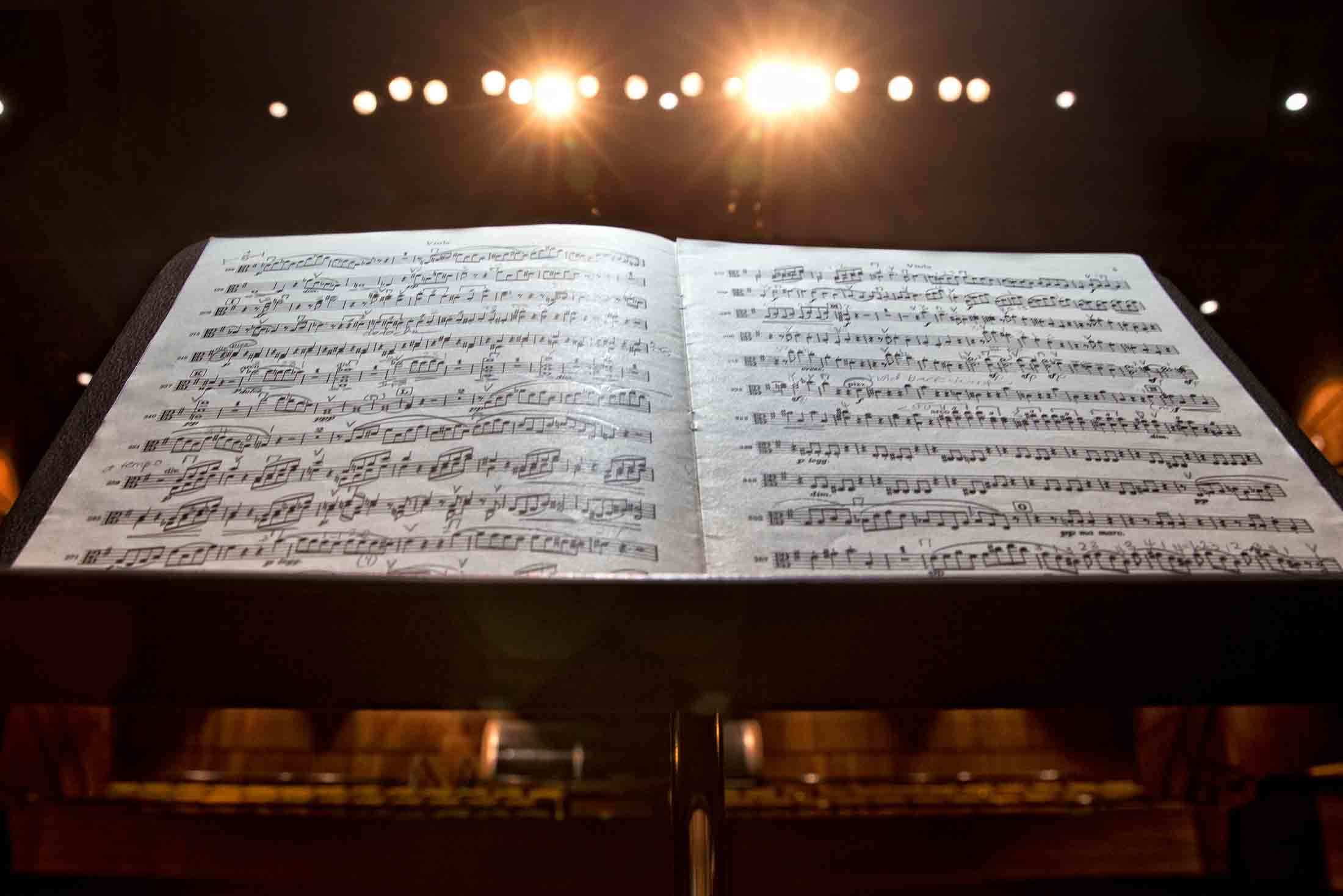 A piece a sheet music on a stand facing the audience.