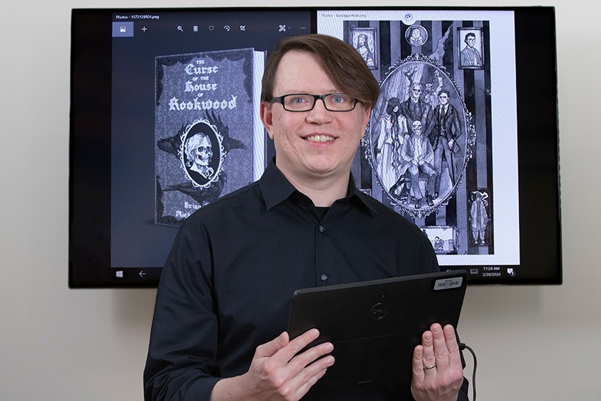 Mike Addison holding tablet