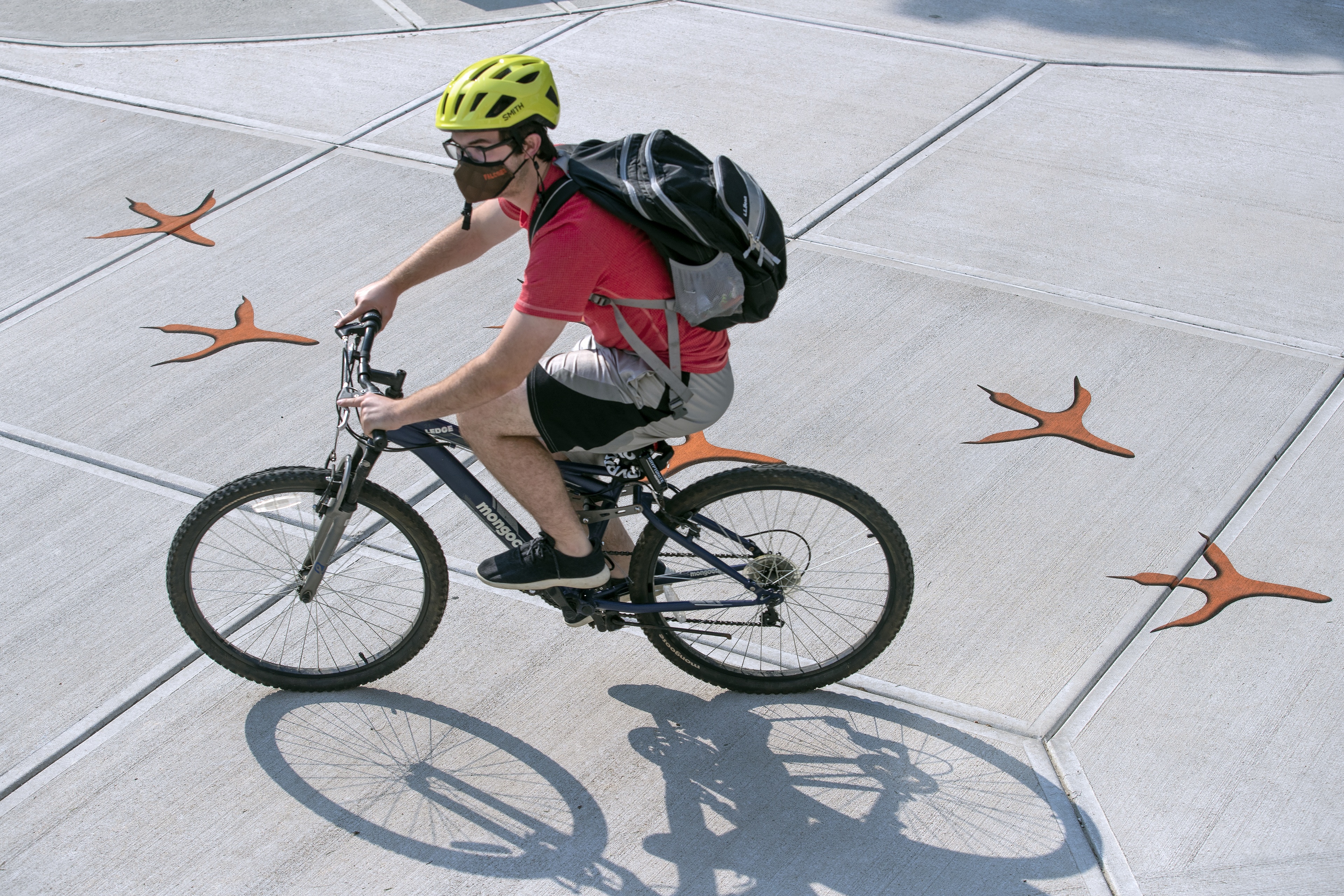 A student bikes to class on the first day of the fall semester
