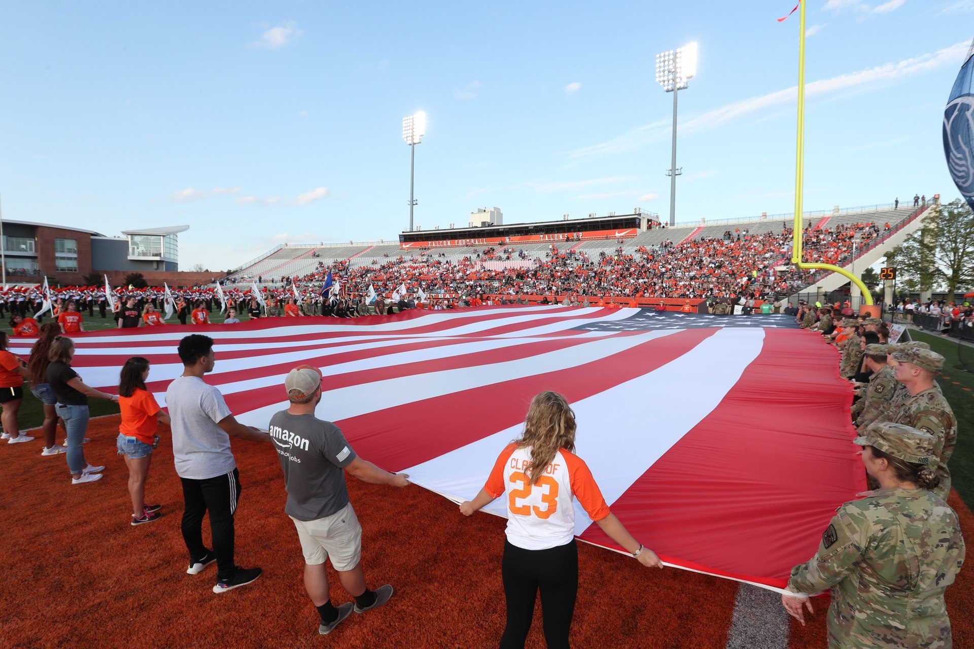 group-of-students-on-field-holding-american-flag