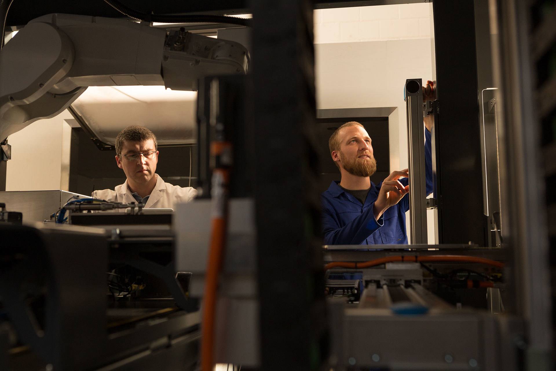 Robotic engineers working in warehouse