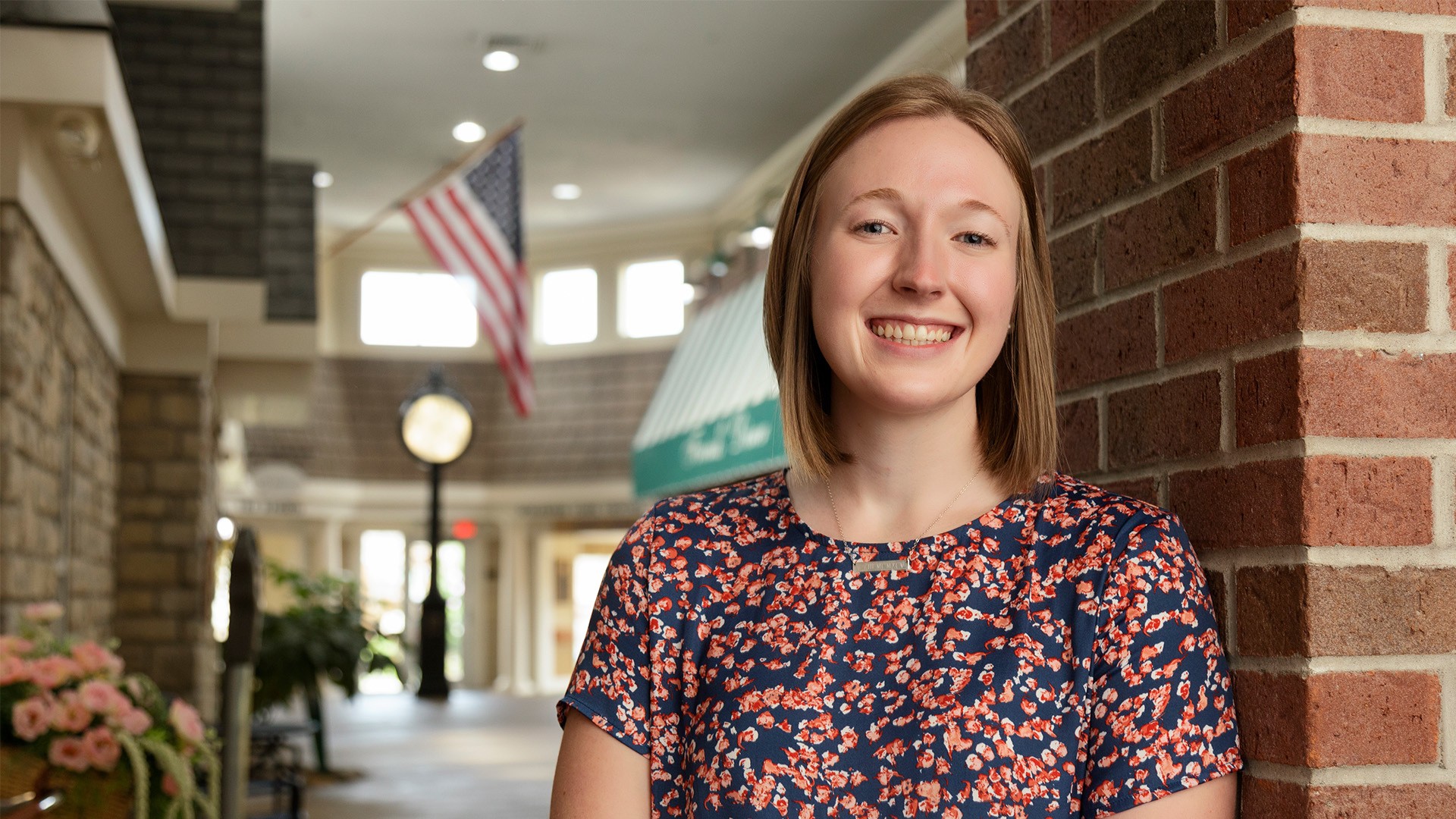 Lindsey Murphy smiling at the end of a hallway