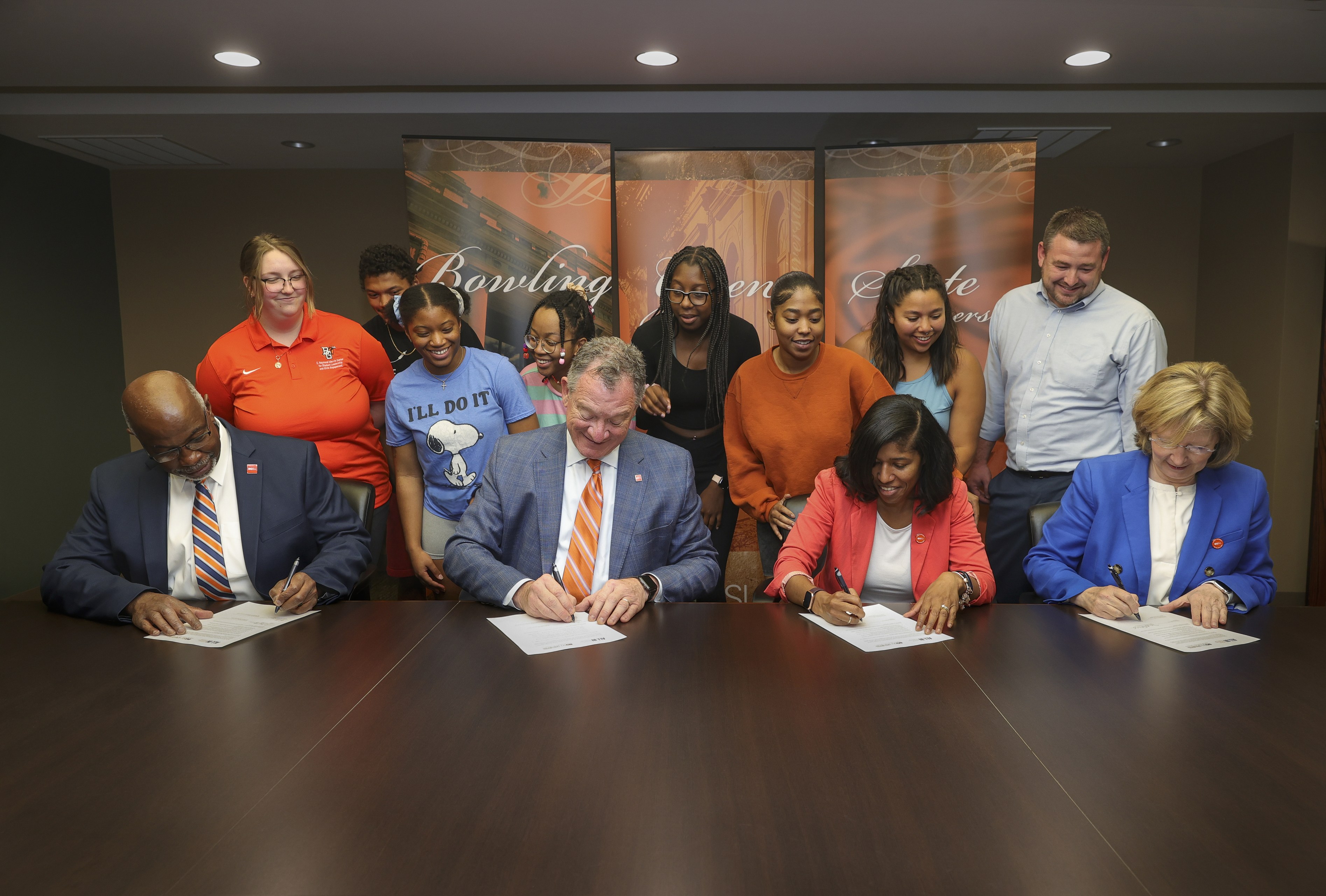 University officials sign a document 