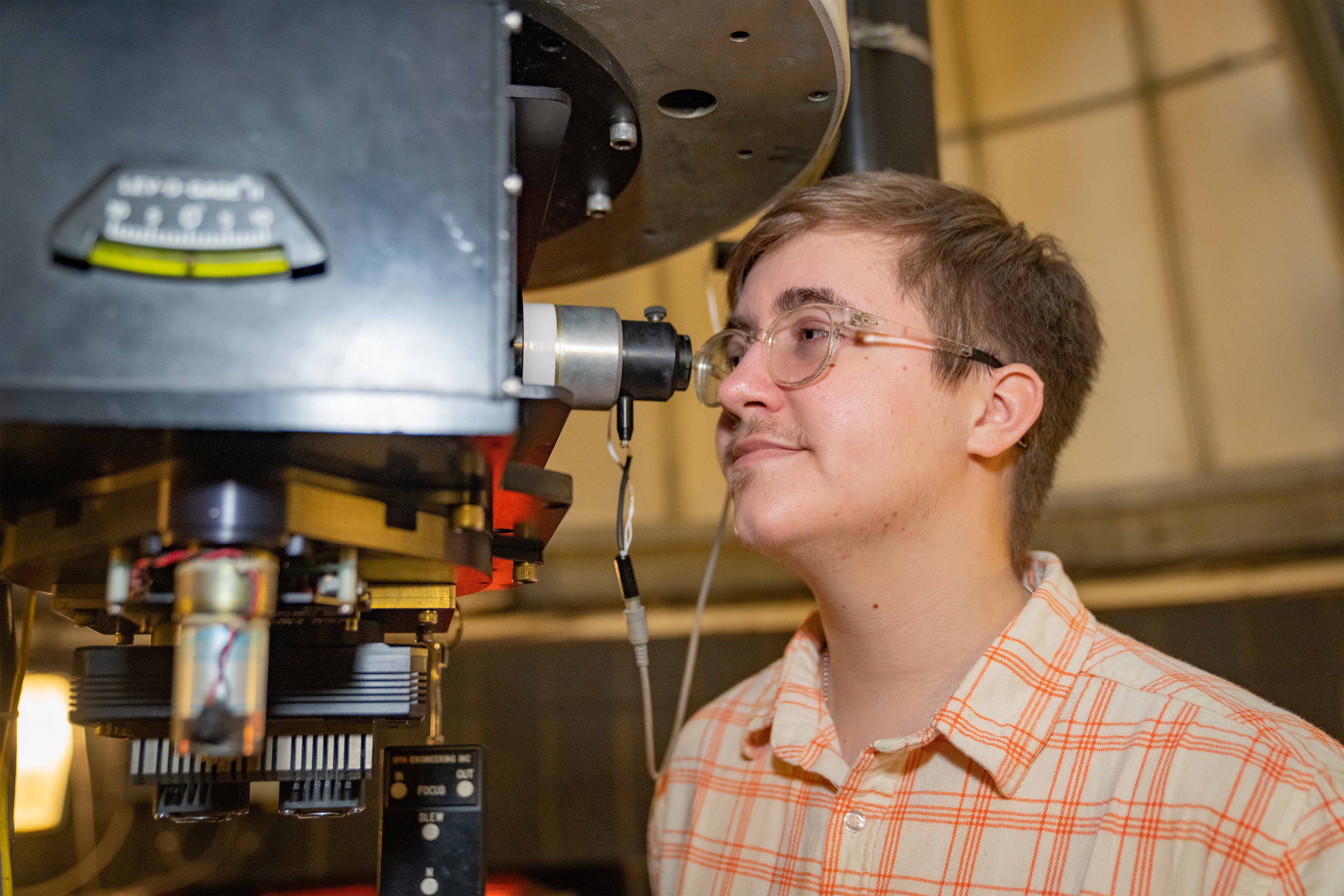 student looking through telescope