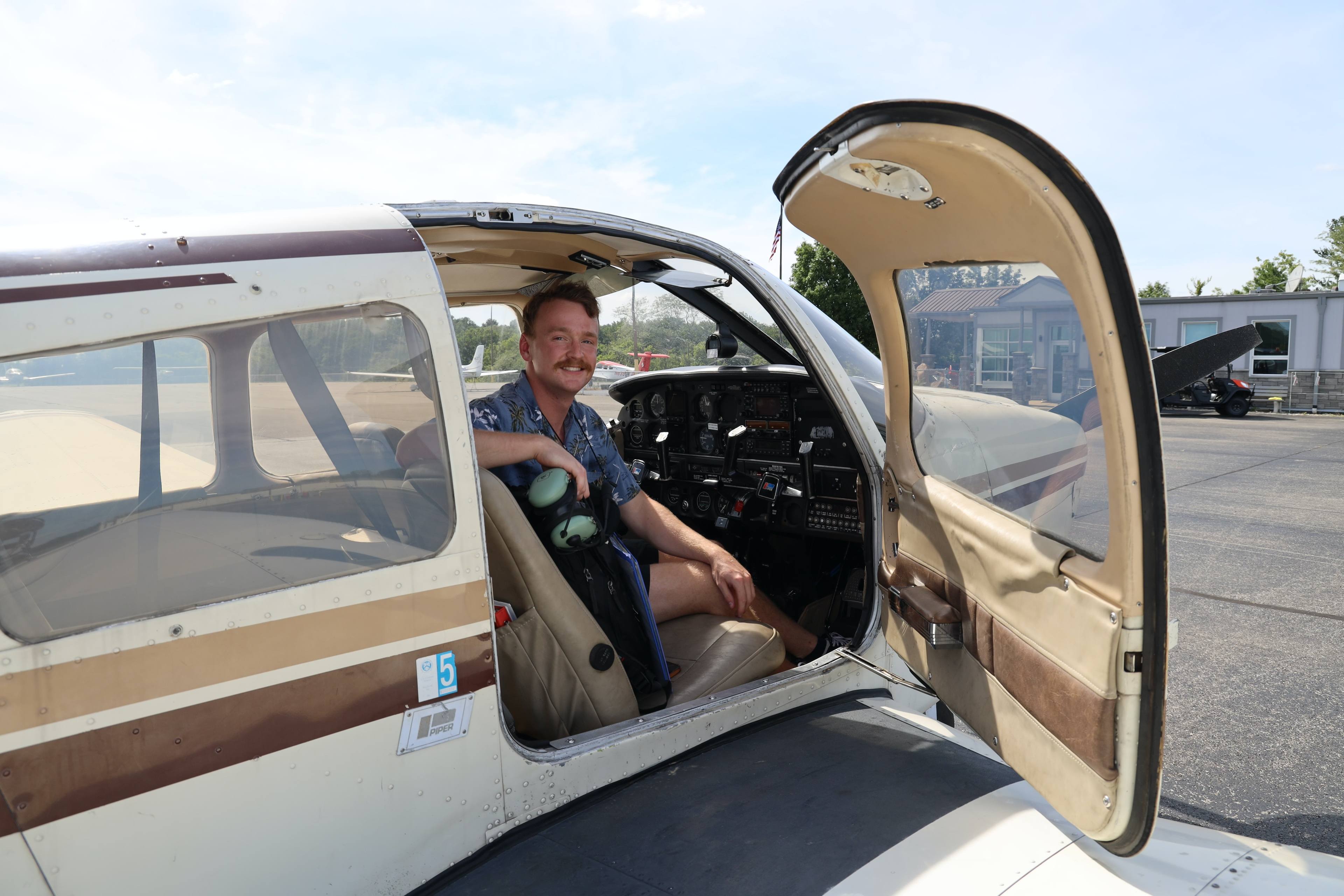 Nicholas Kowalski sitting in an airplane.