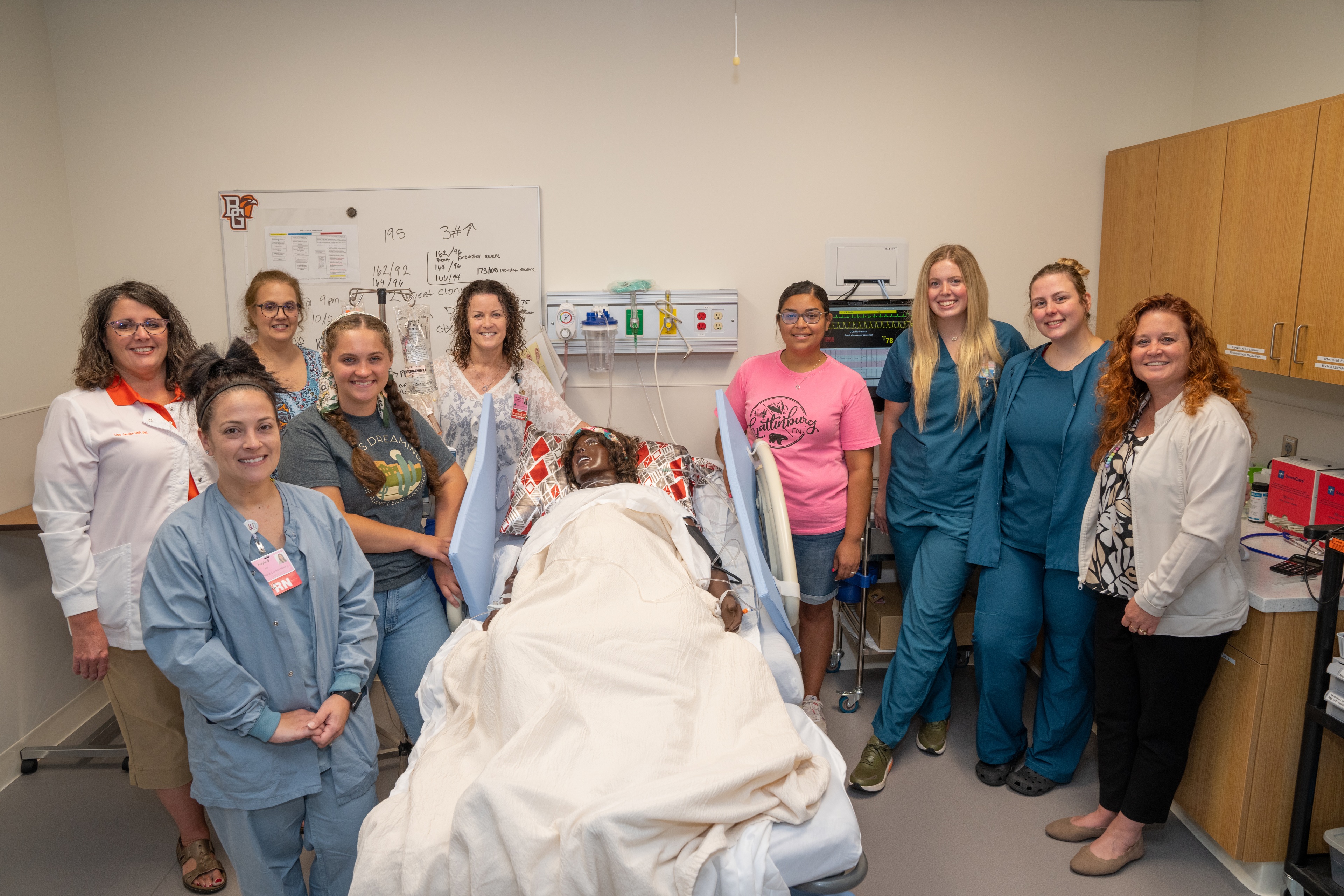 A group of nursing students and nursing instructors smiling