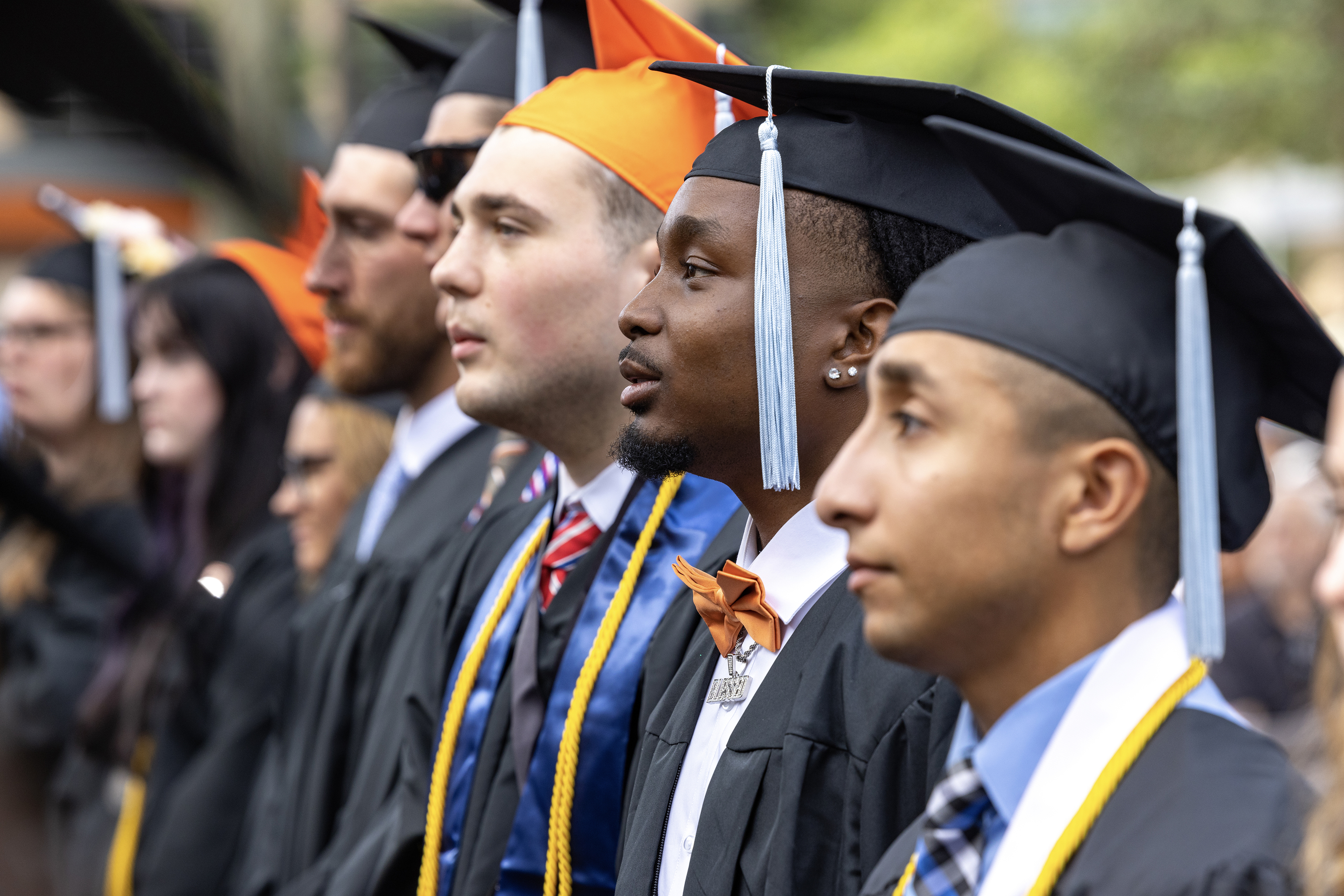 BGSU graduates stand up