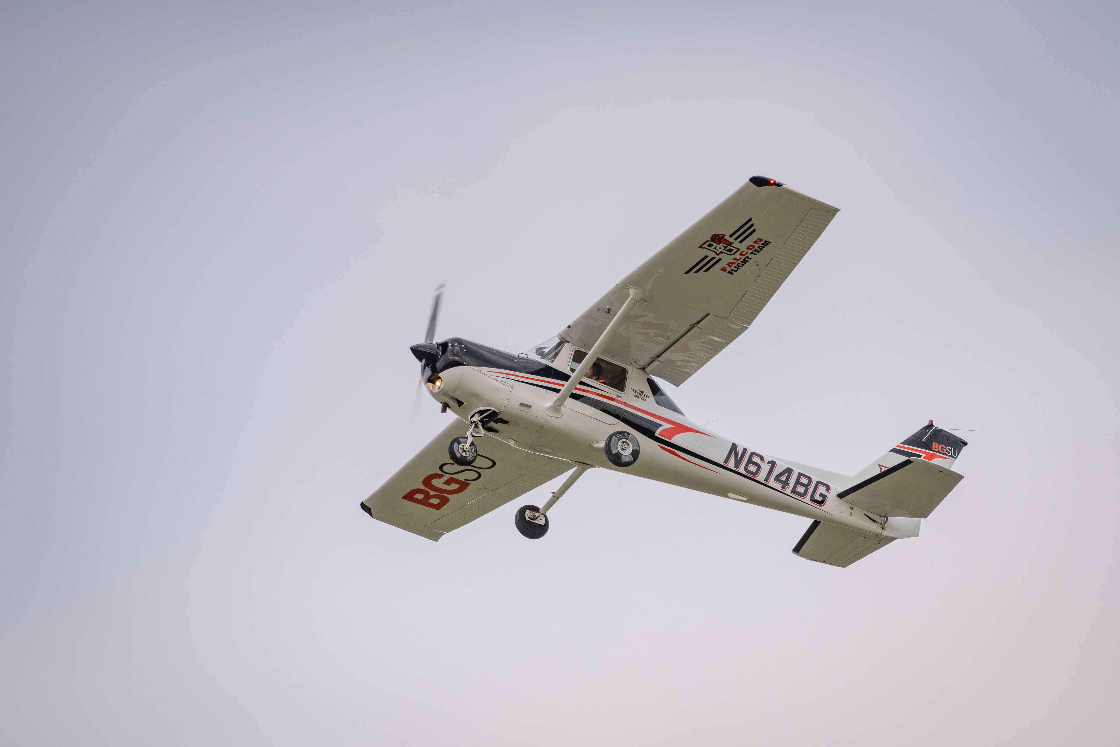 The view underneath of a BGSU airplane in flight.