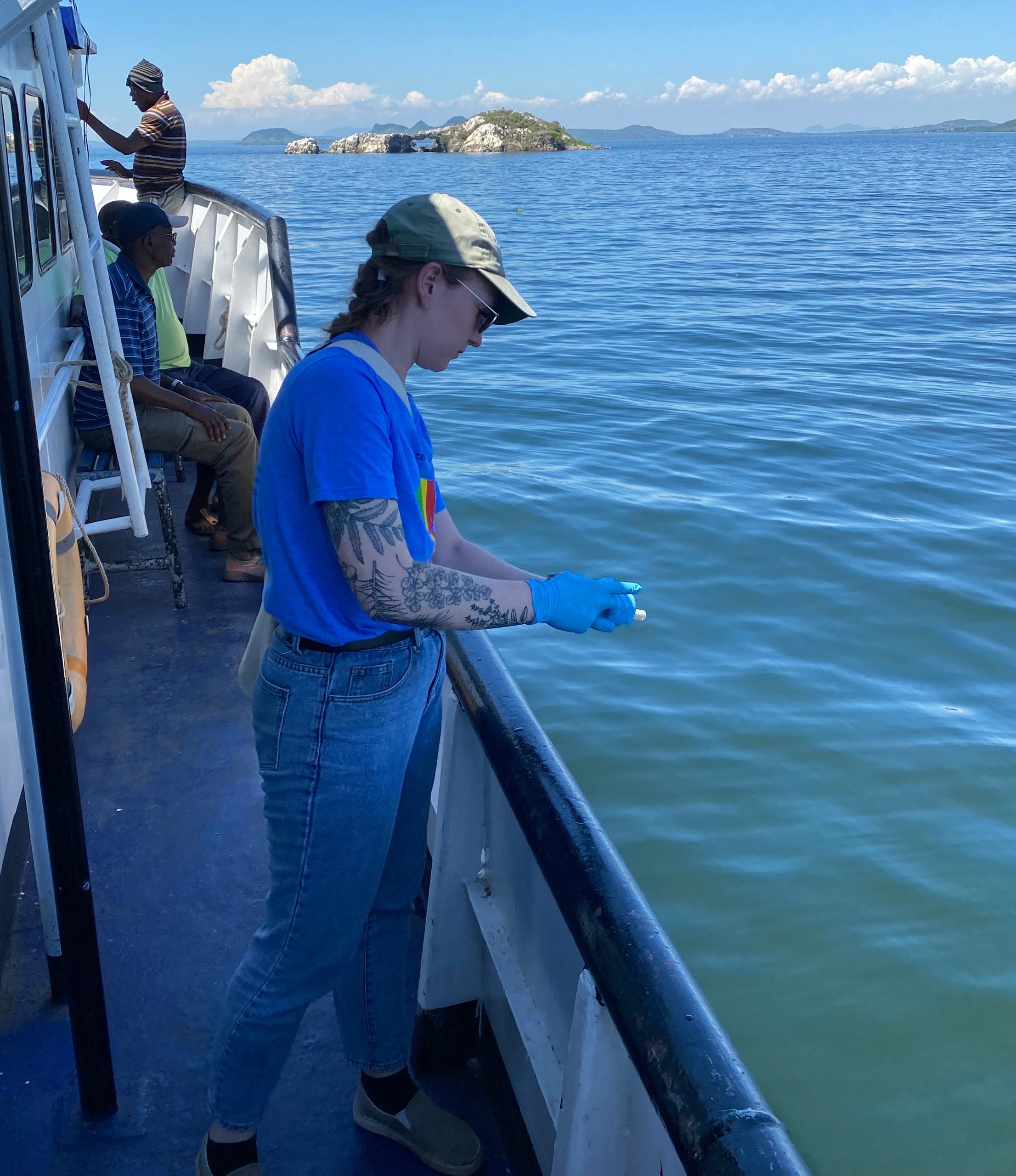 BGSU student Kate Brown stands near the edge of a research vessel and processes an aspect of a research experiment