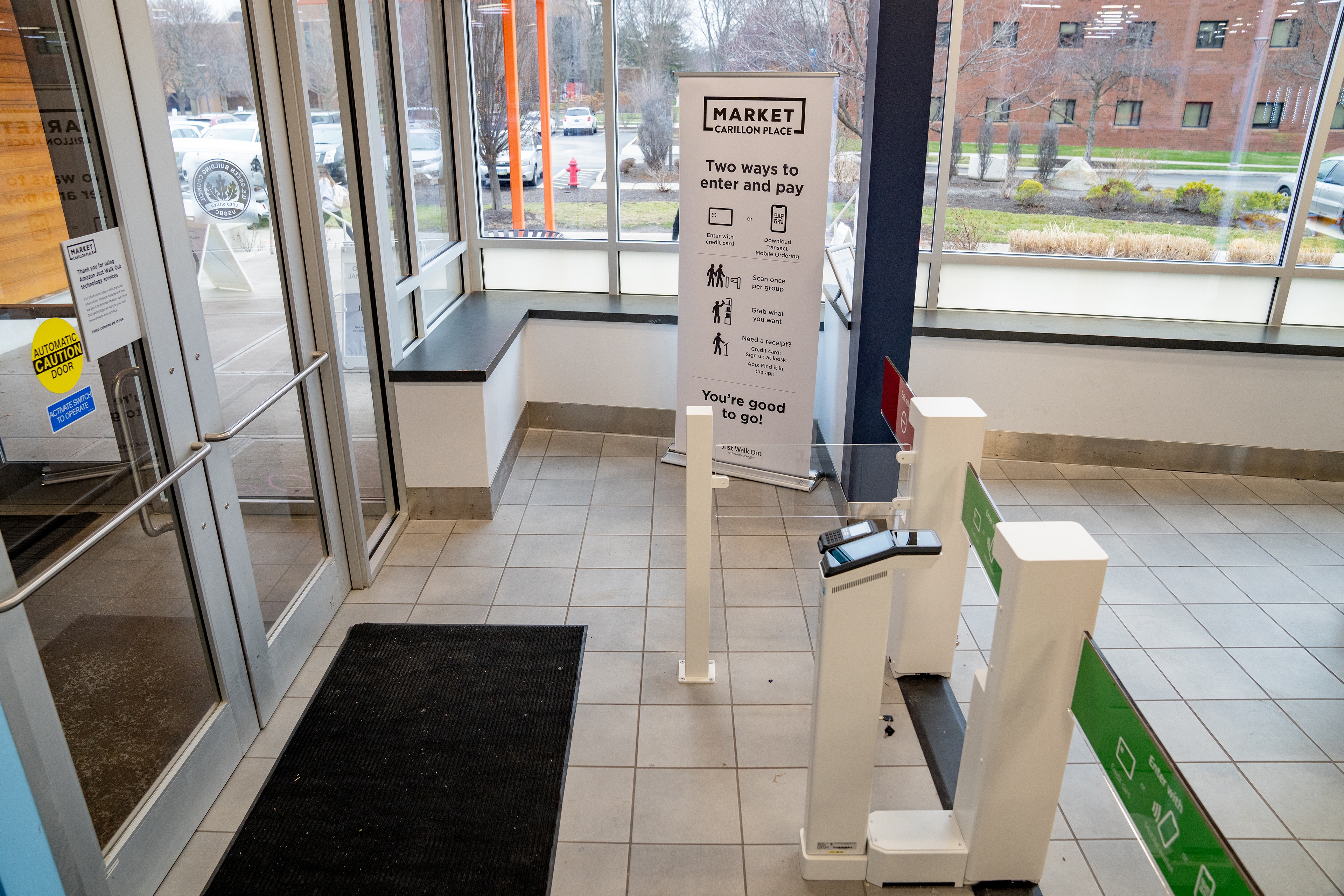 A banner at the main entrance to the Market at Carillon Place shows shoppers how they can enter and experience the new store.