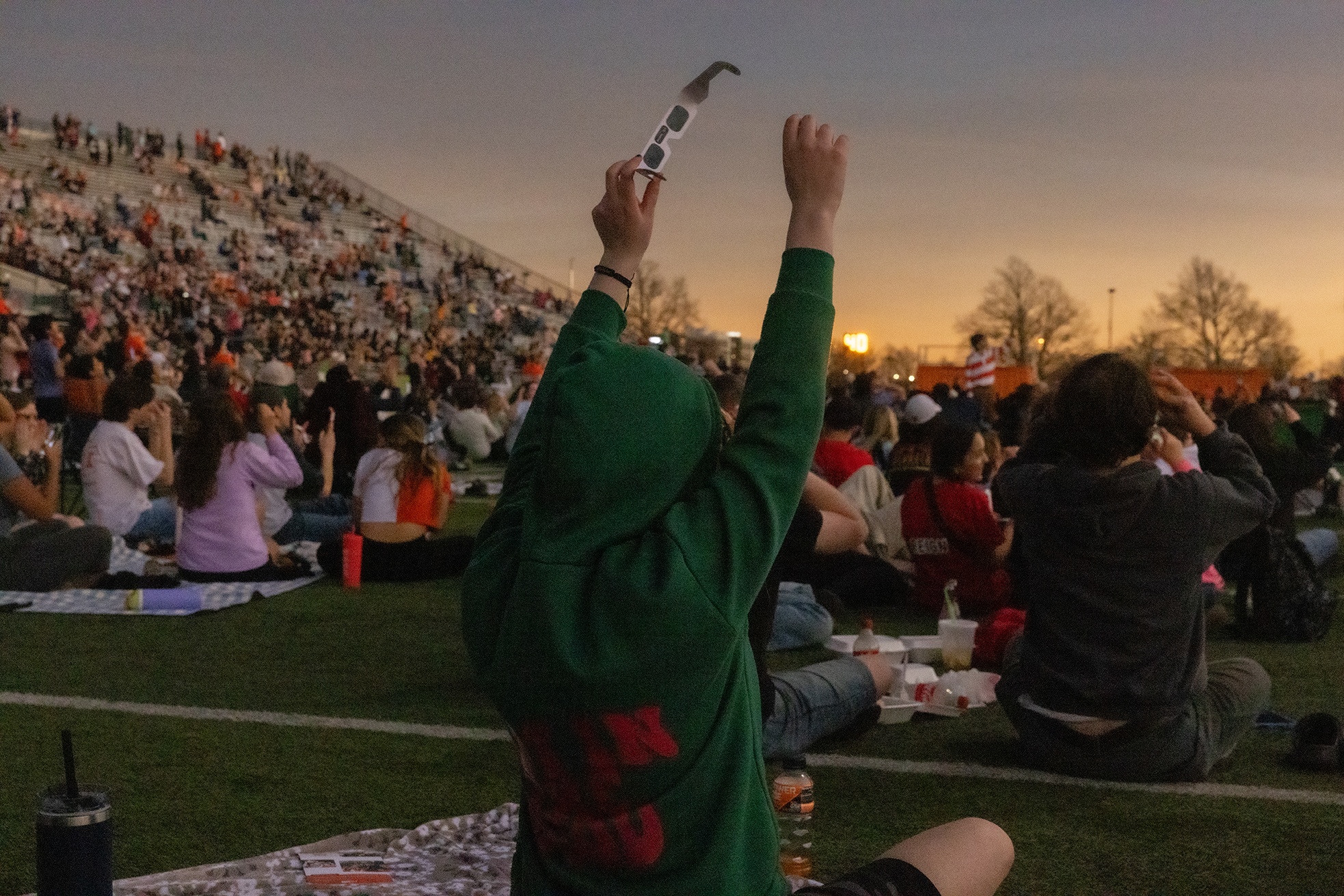 Eclipse viewer raises her arms