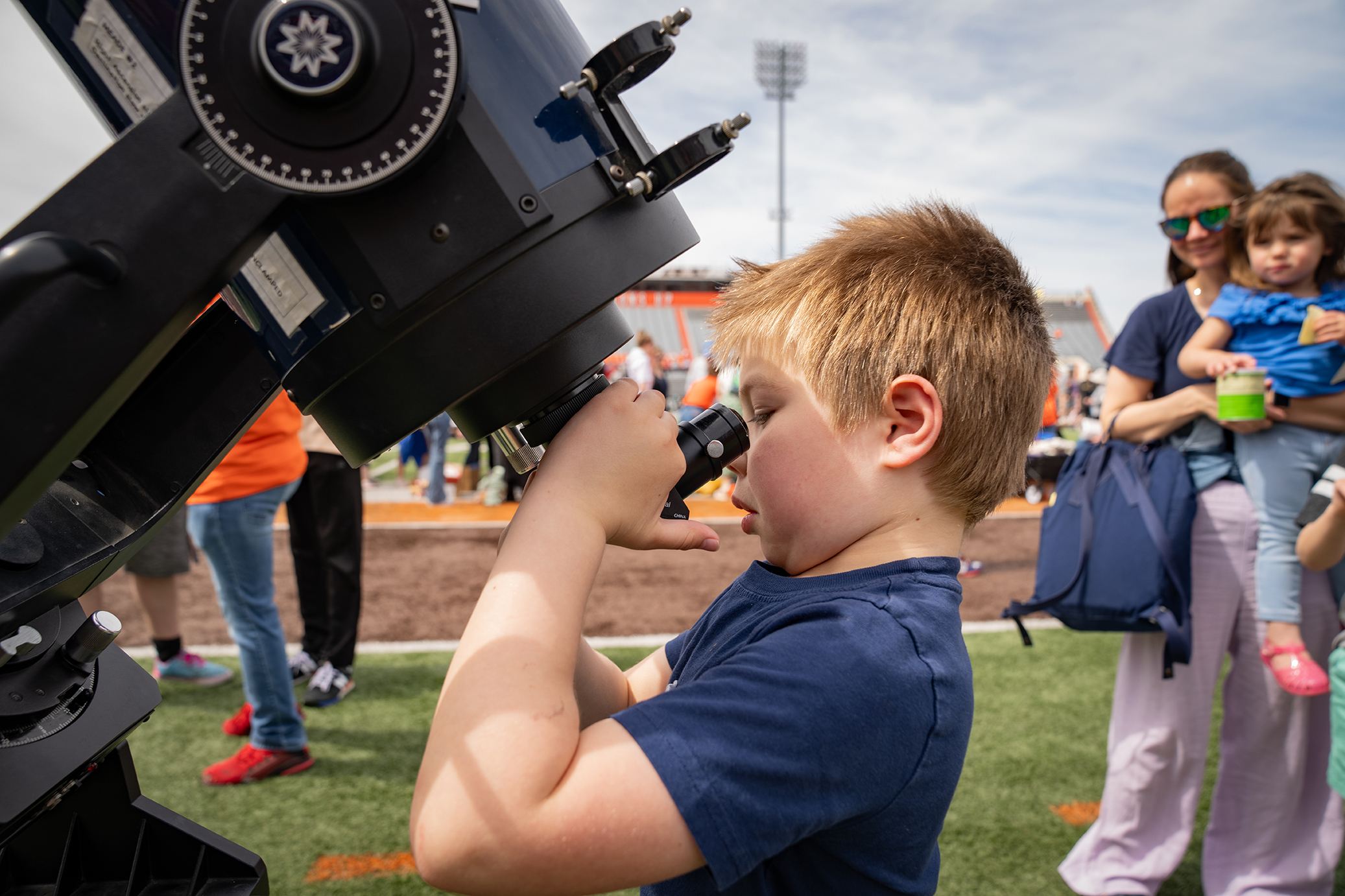 A person looks through a telescope
