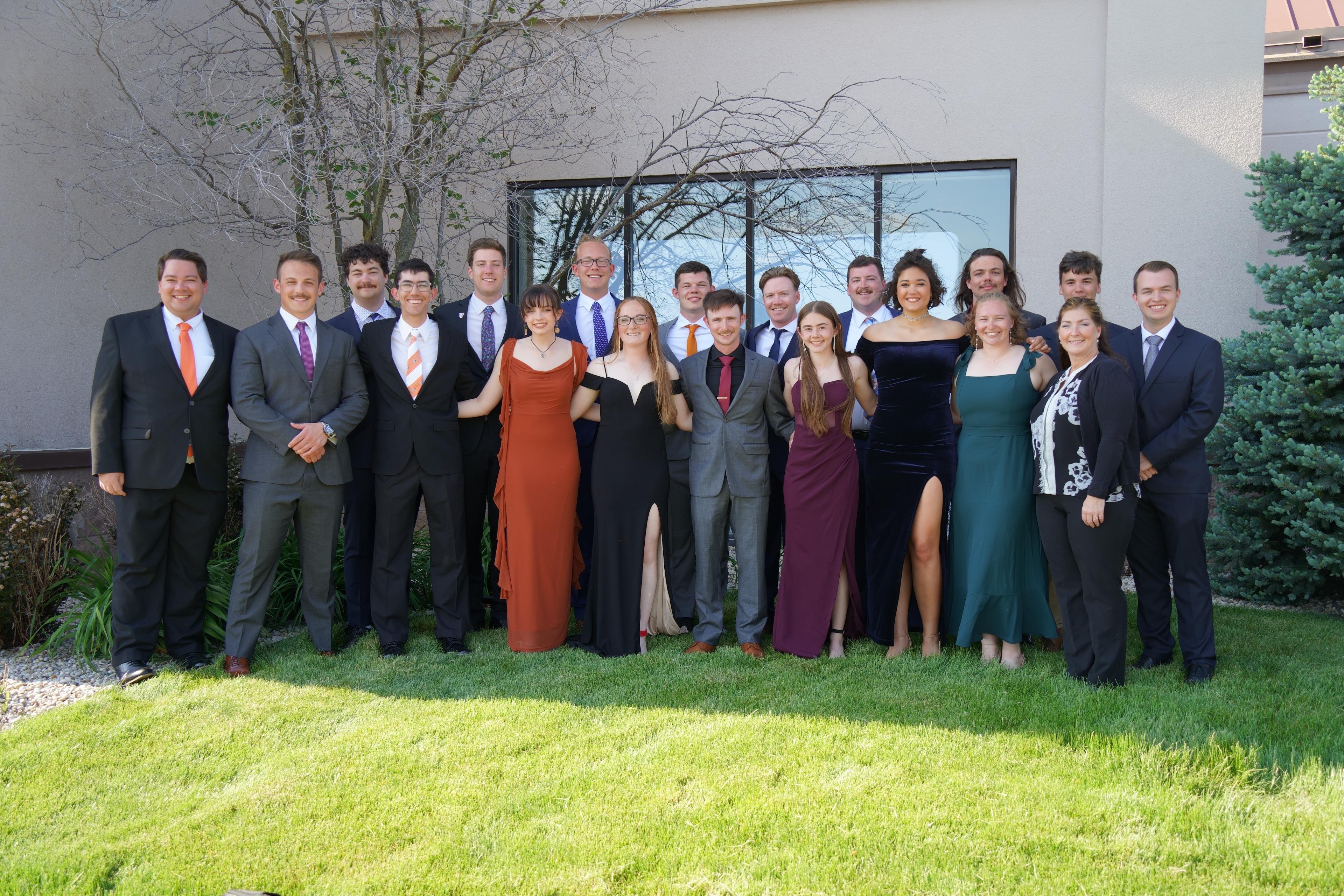 A group of people stand together for a picture.