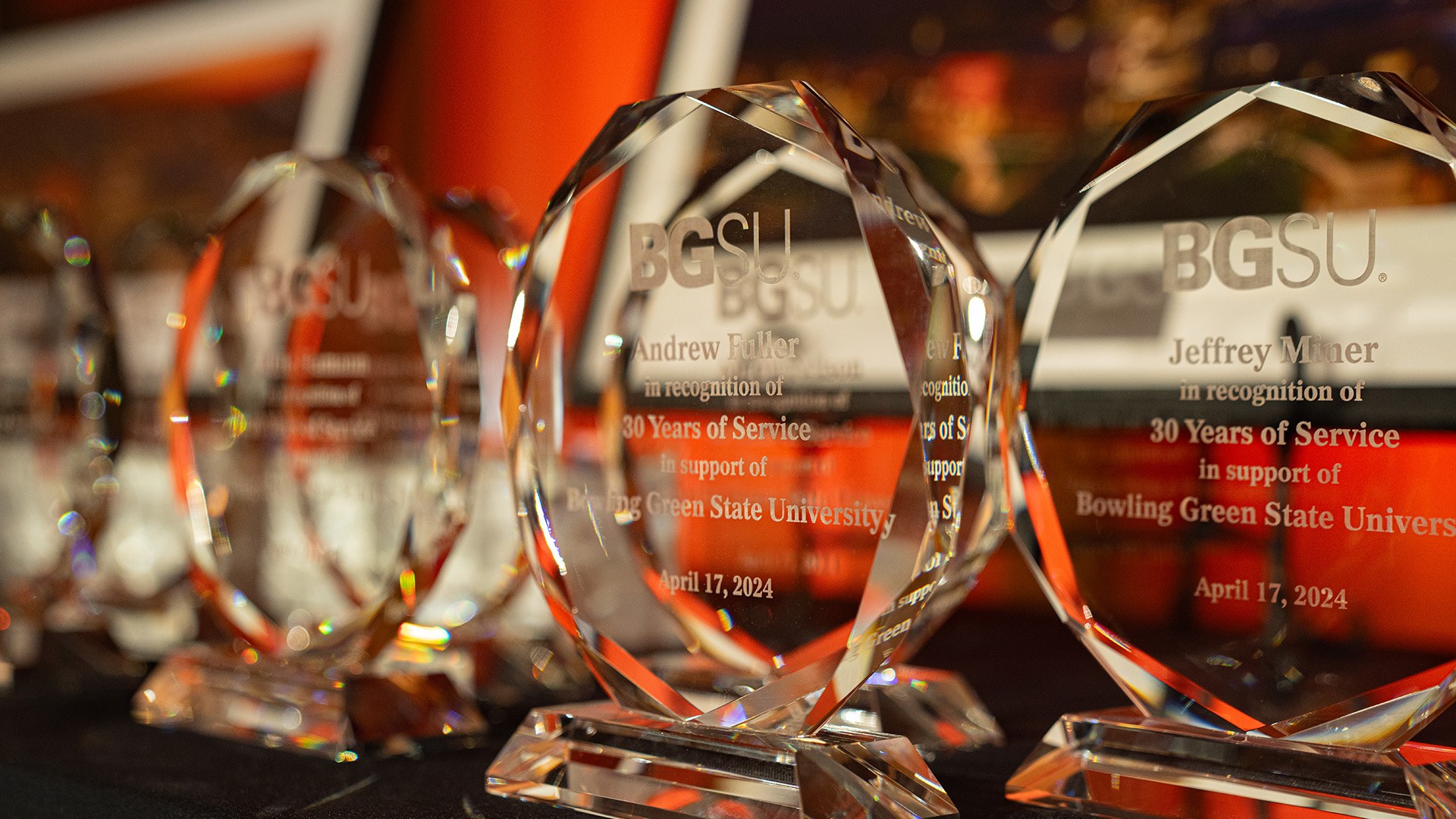 Glass trophies line a table