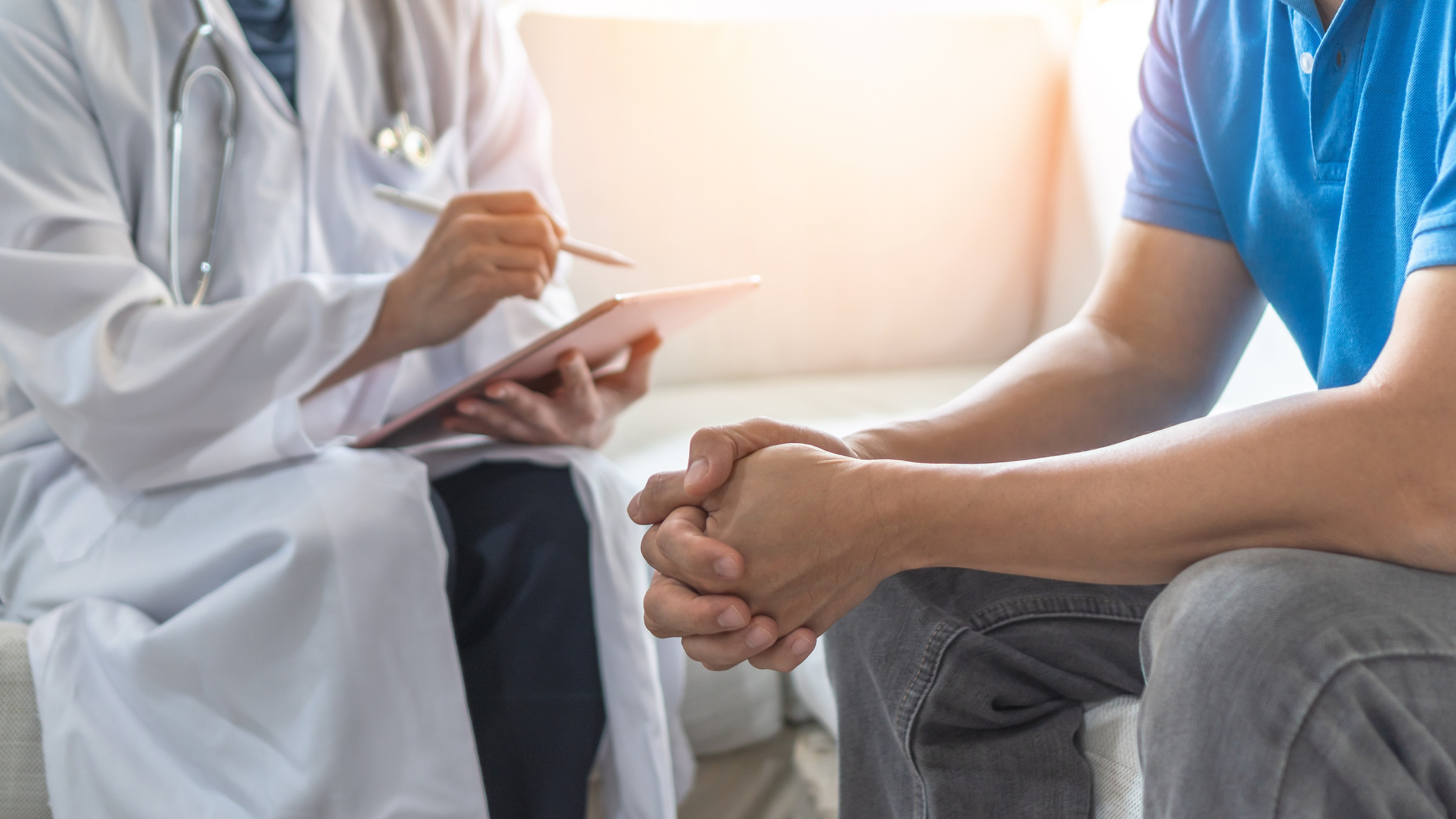 Man sits and talks with doctor