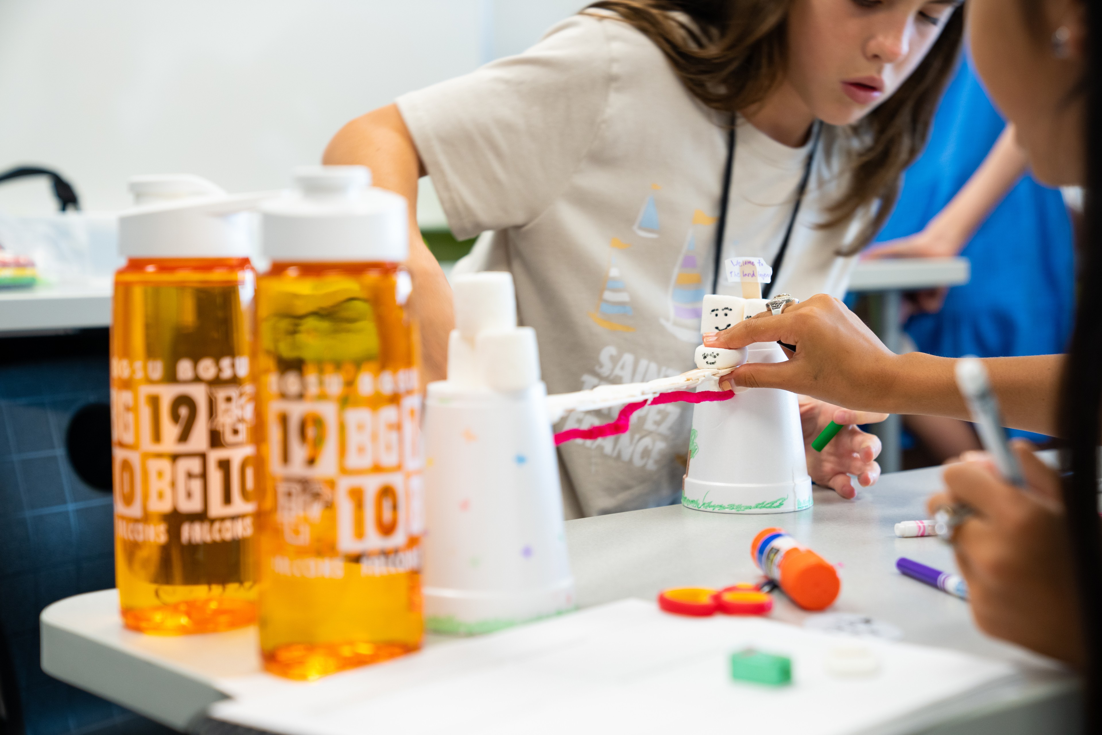 Students build a bridge out of art supplies
