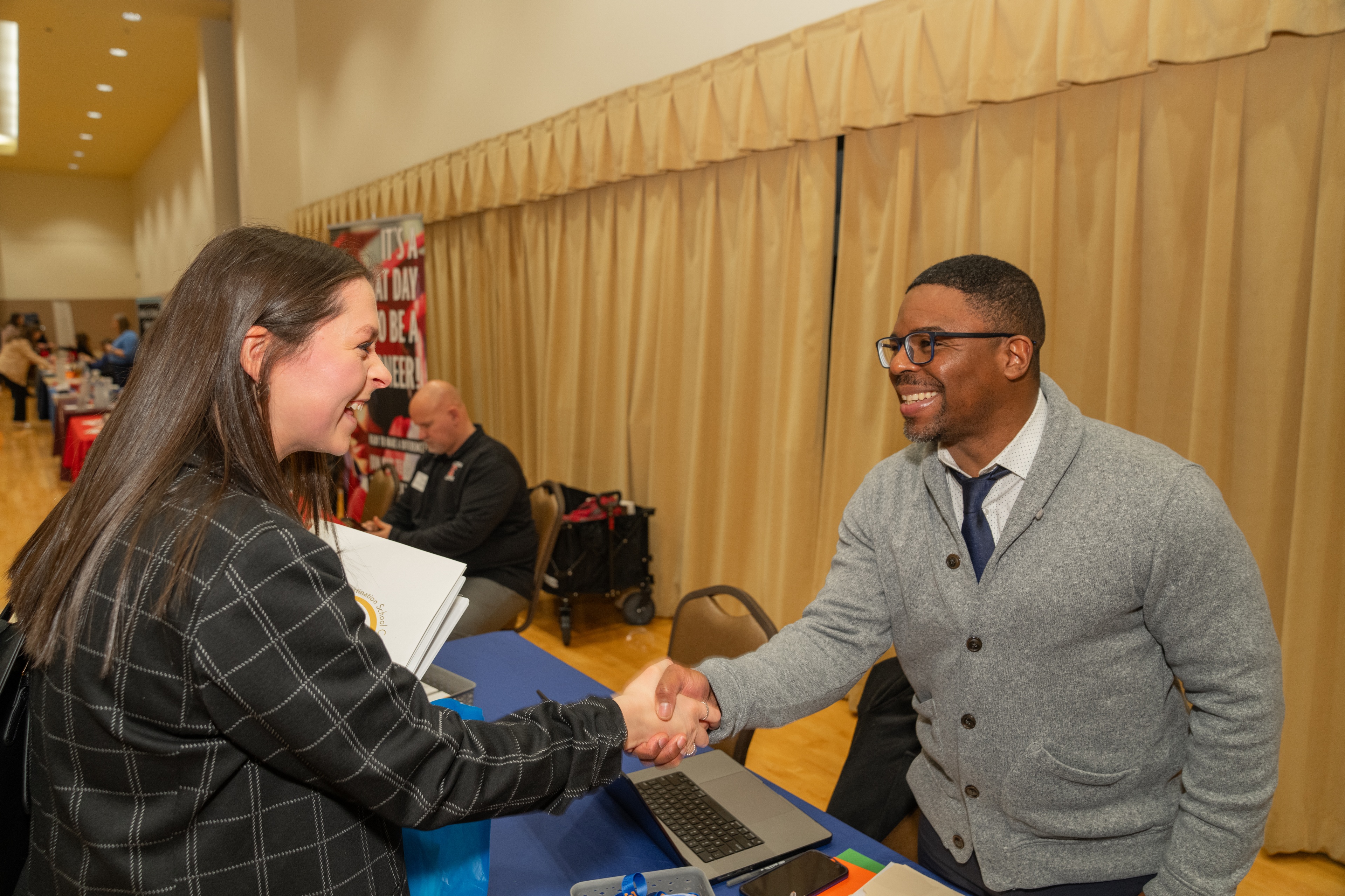 A person shaking hands with another person.