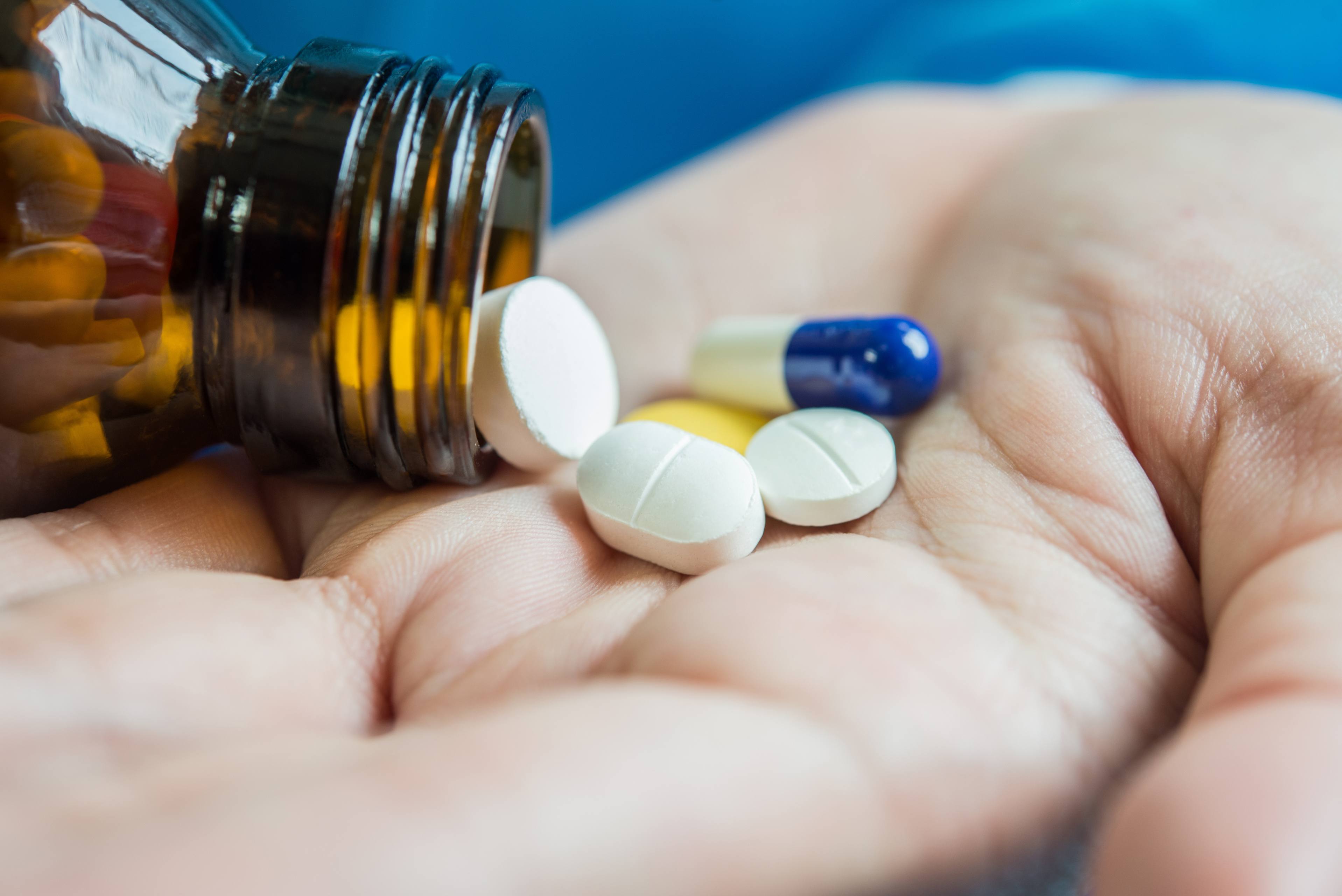 Medication being emptied into palm of hand