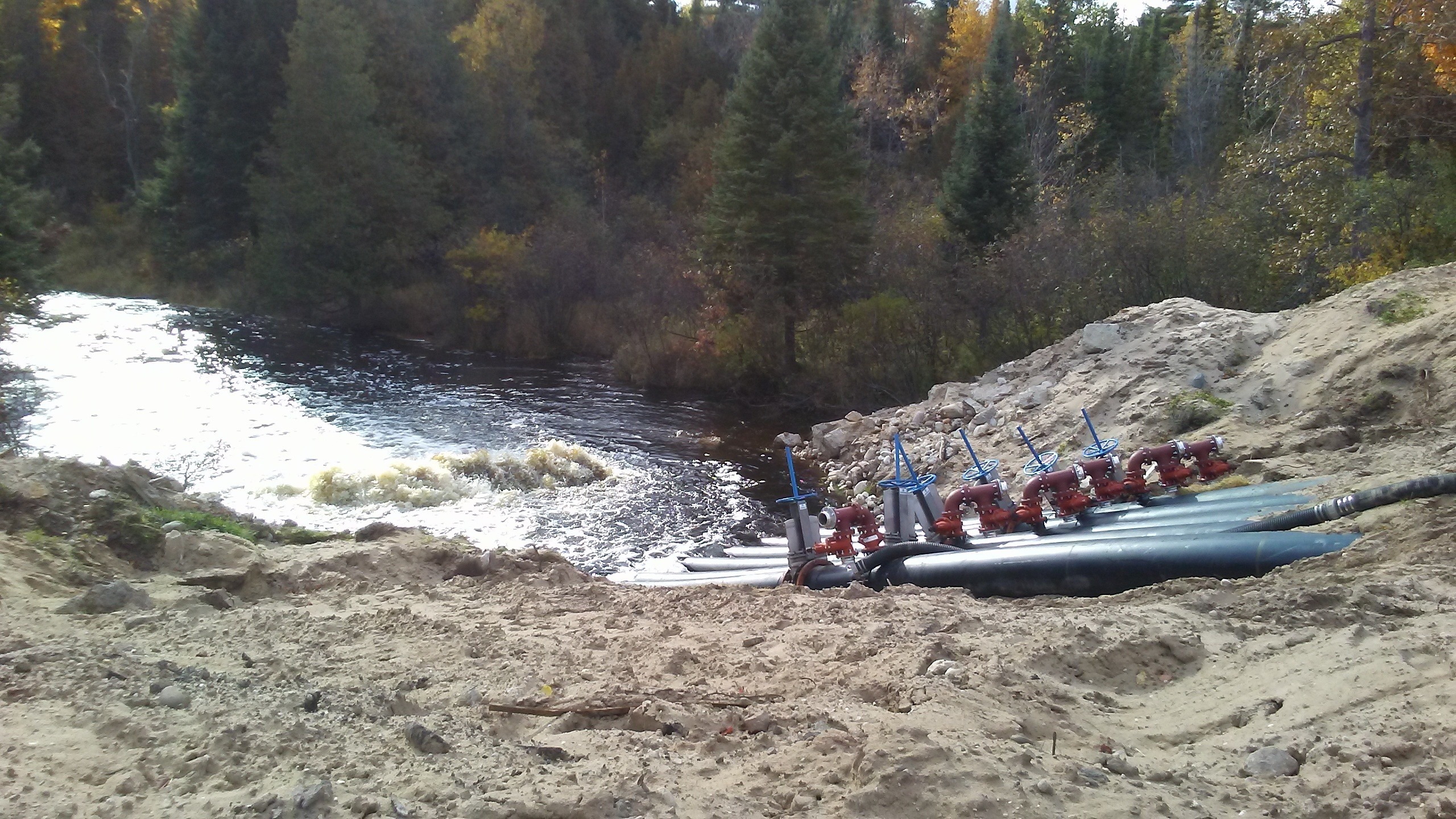 Scientific equipment rests near the bank of a river. 