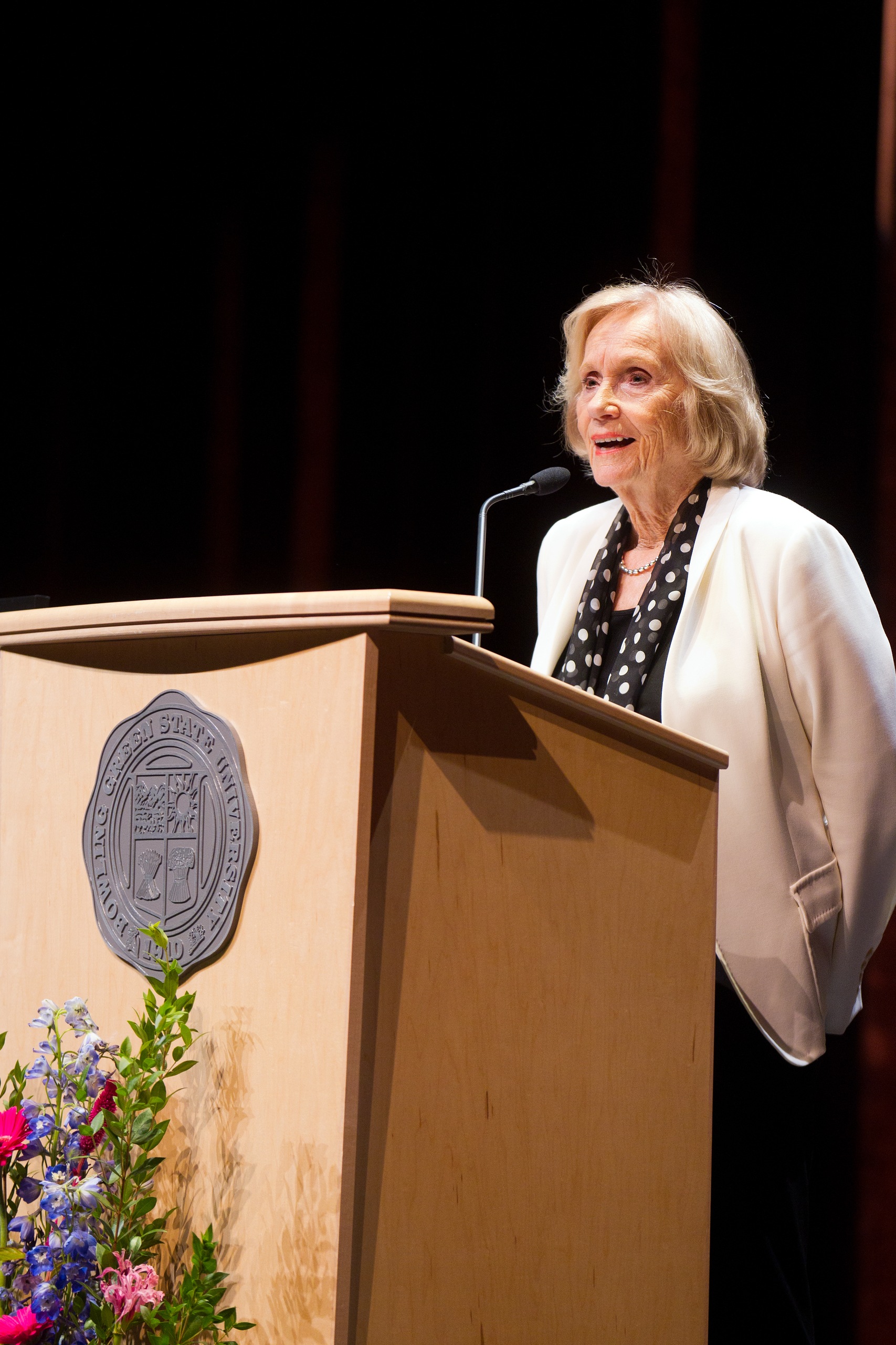 A woman speaks at a podium