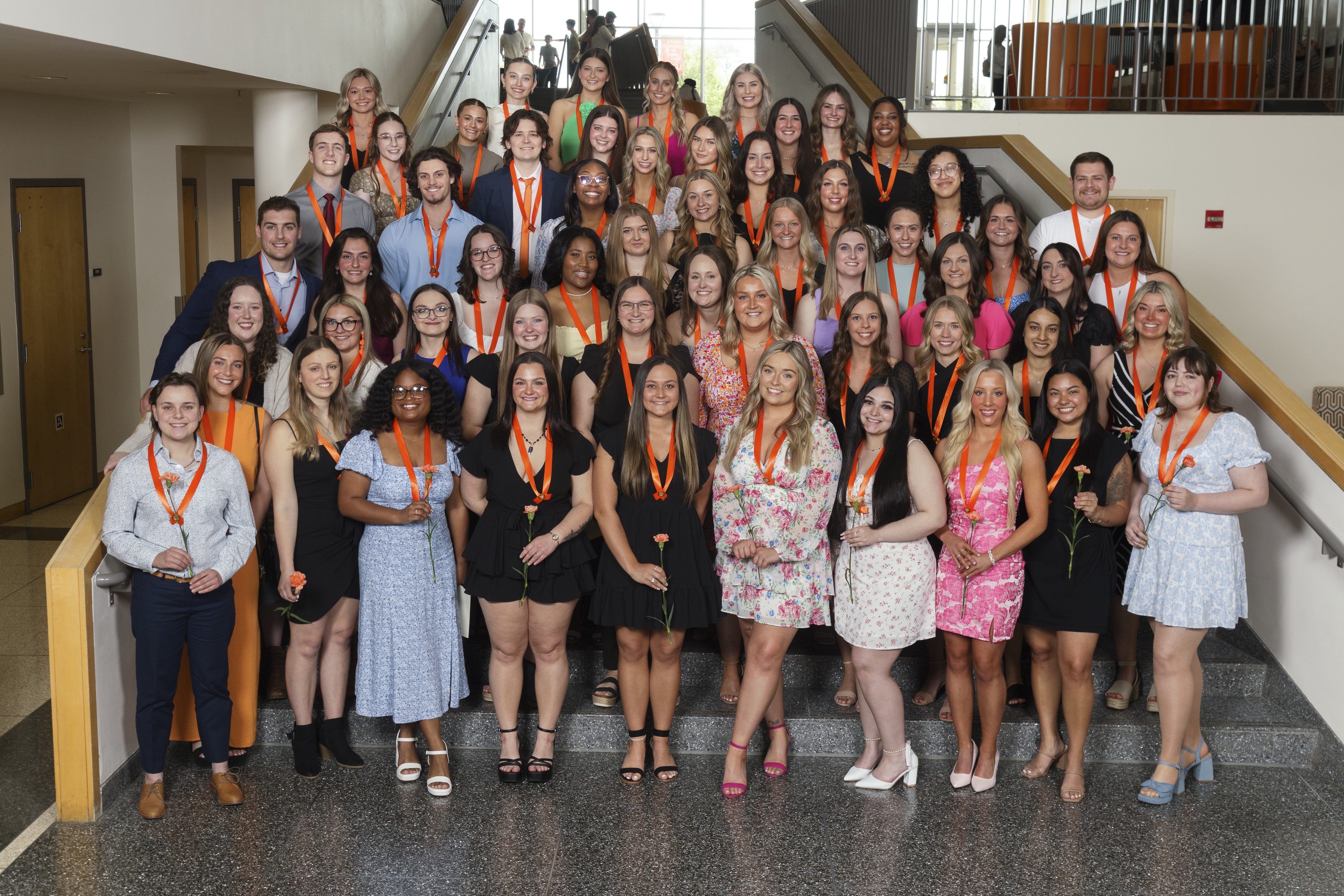 A group of nursing students stand on a stairway.