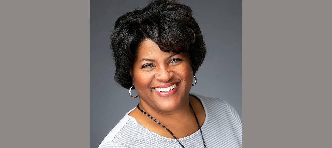 Woman wearing silver hoop earrings smiles 