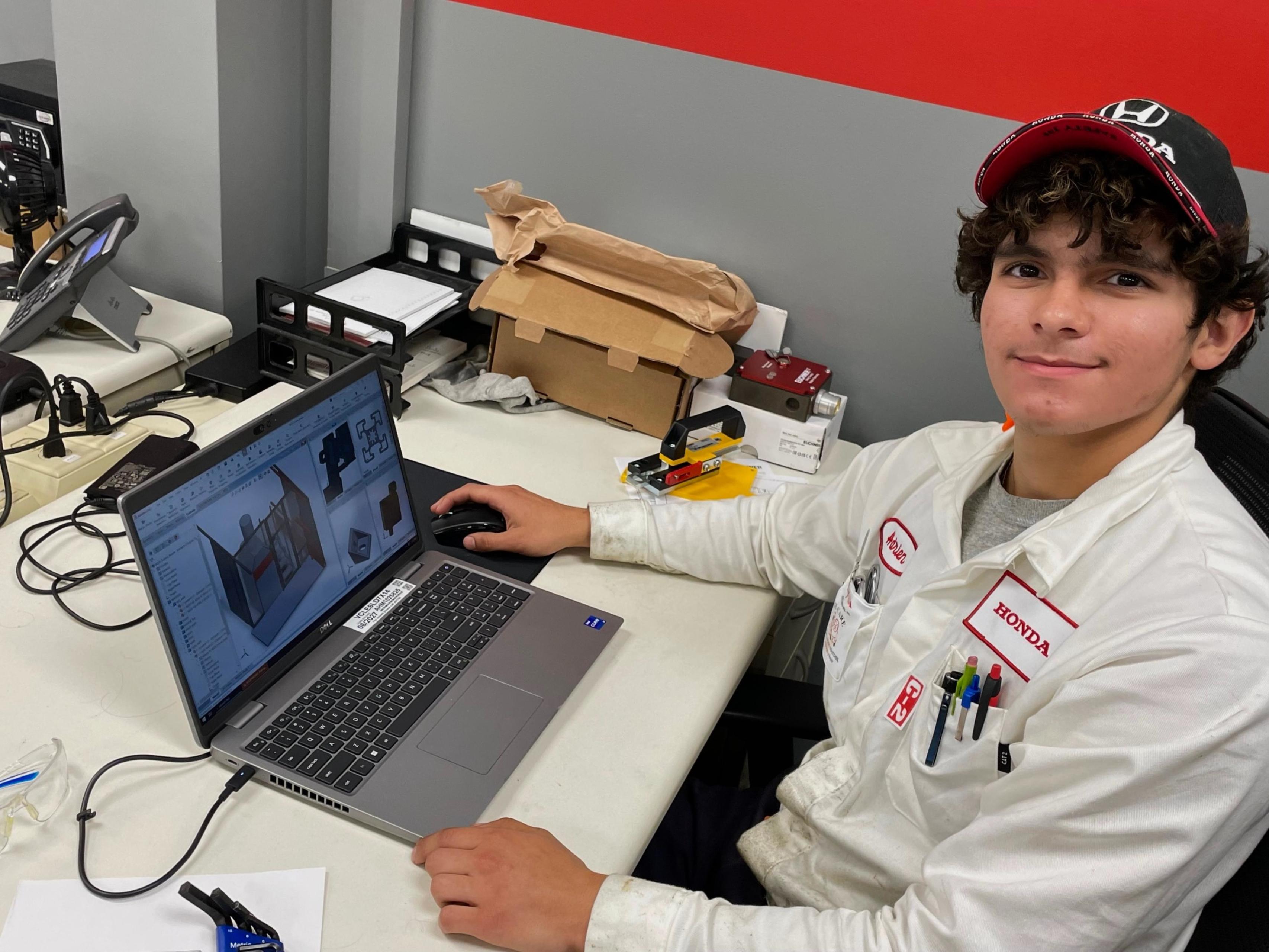BGSU student Adrien Tolento works on a computer at a desk. 