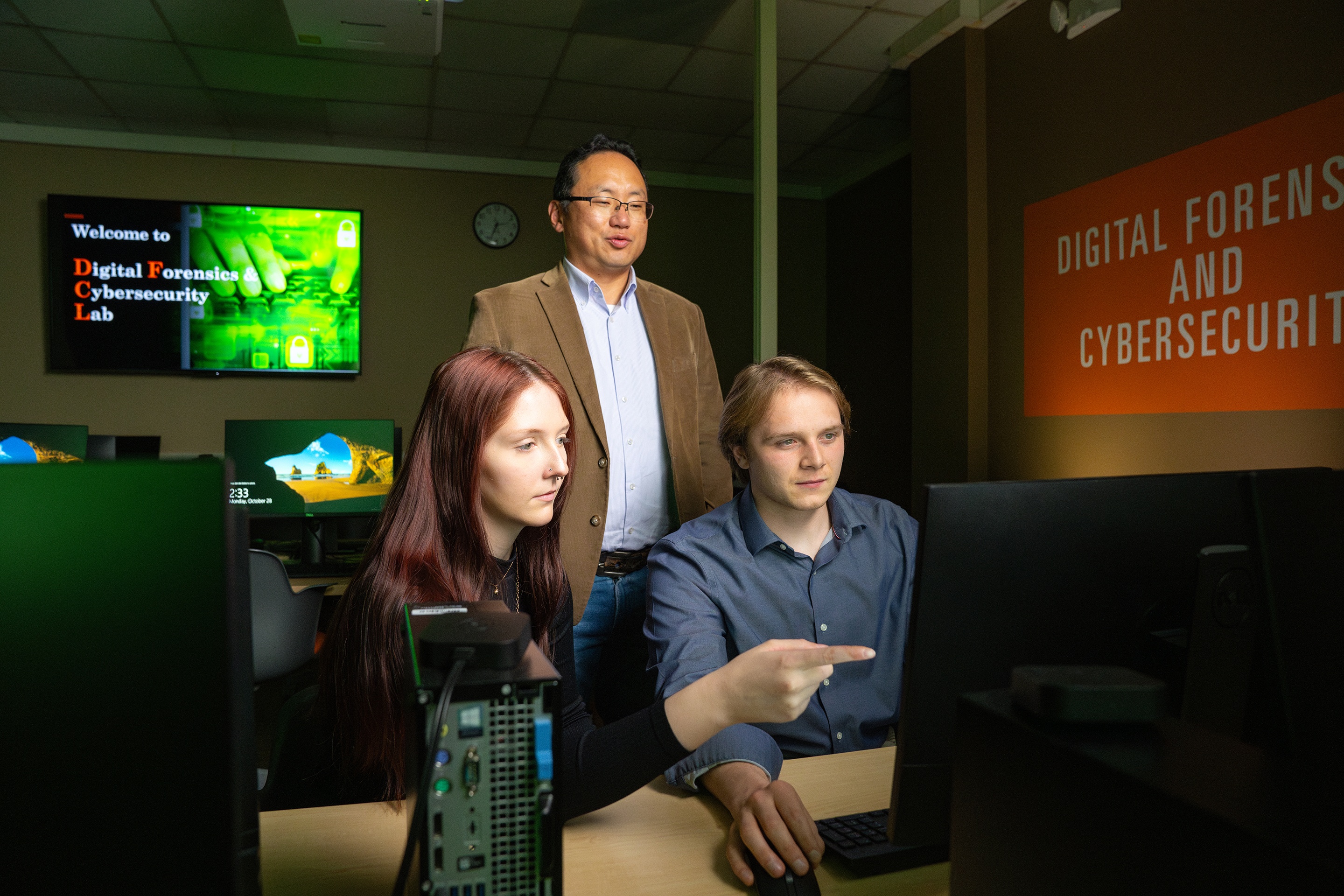 Students in the BGSU computer science program looking at a screen