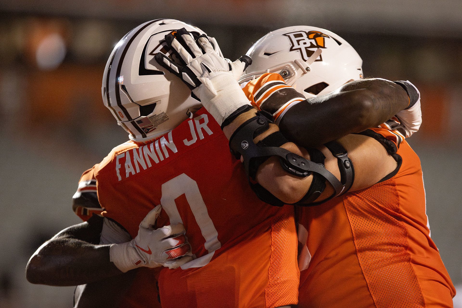Two football players celebrate.