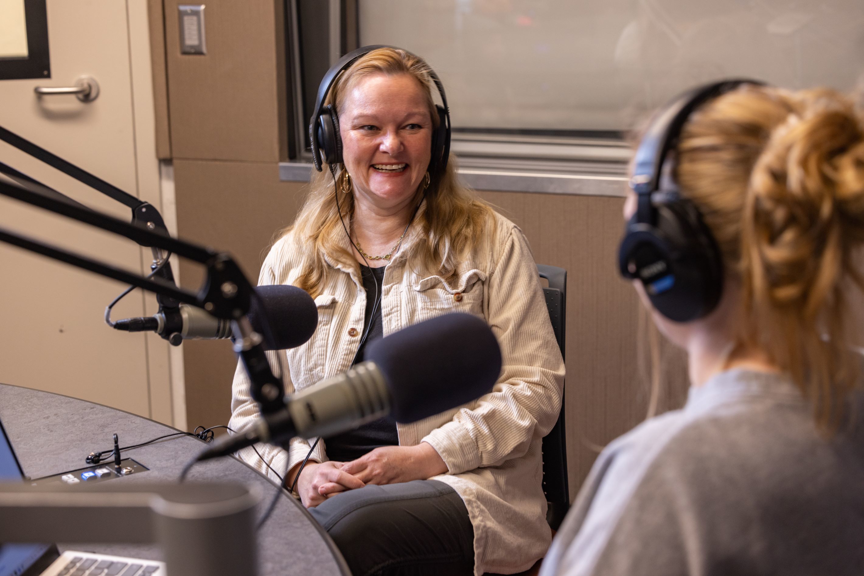 A woman sits for a radio interview
