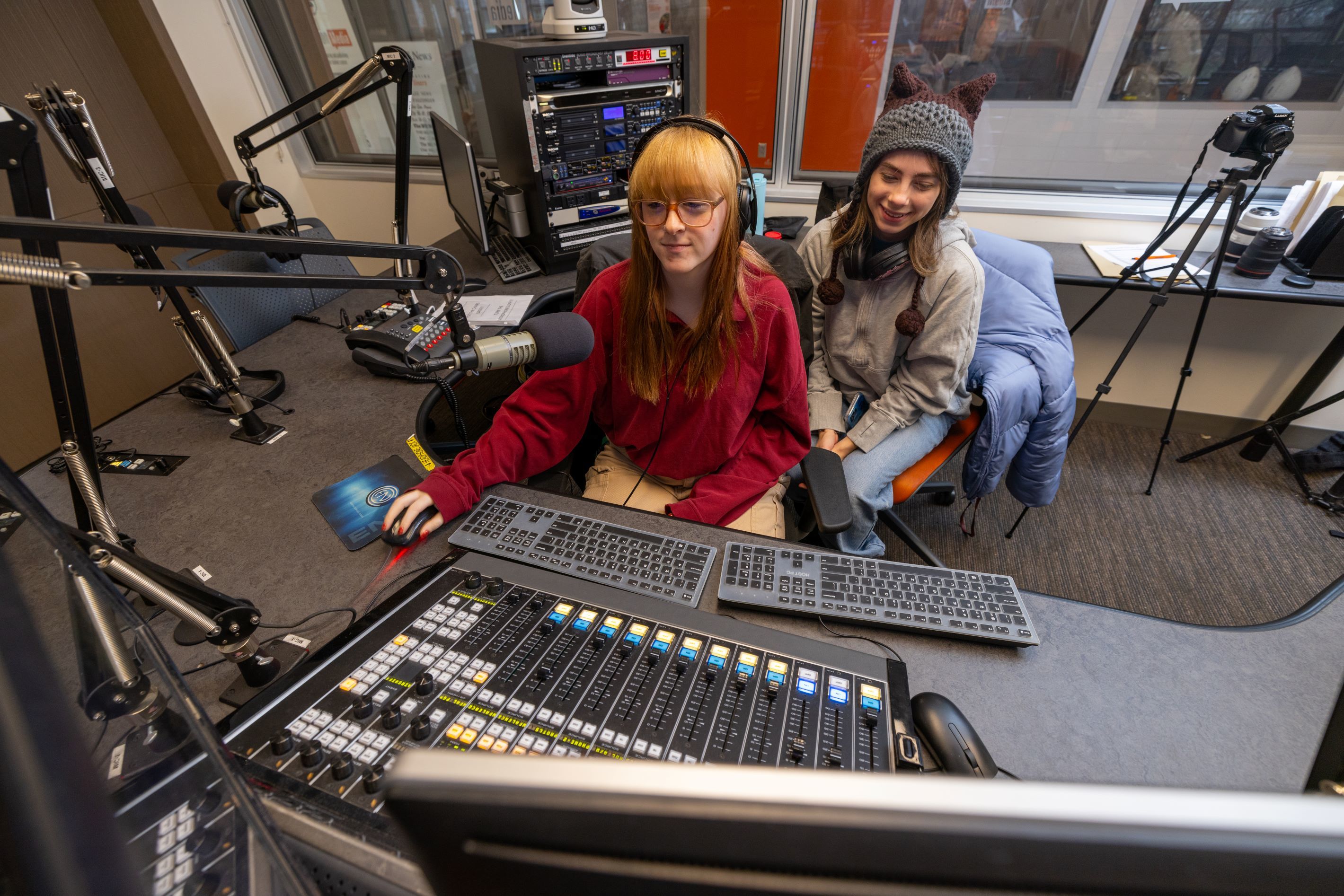 Two students work on an audio board