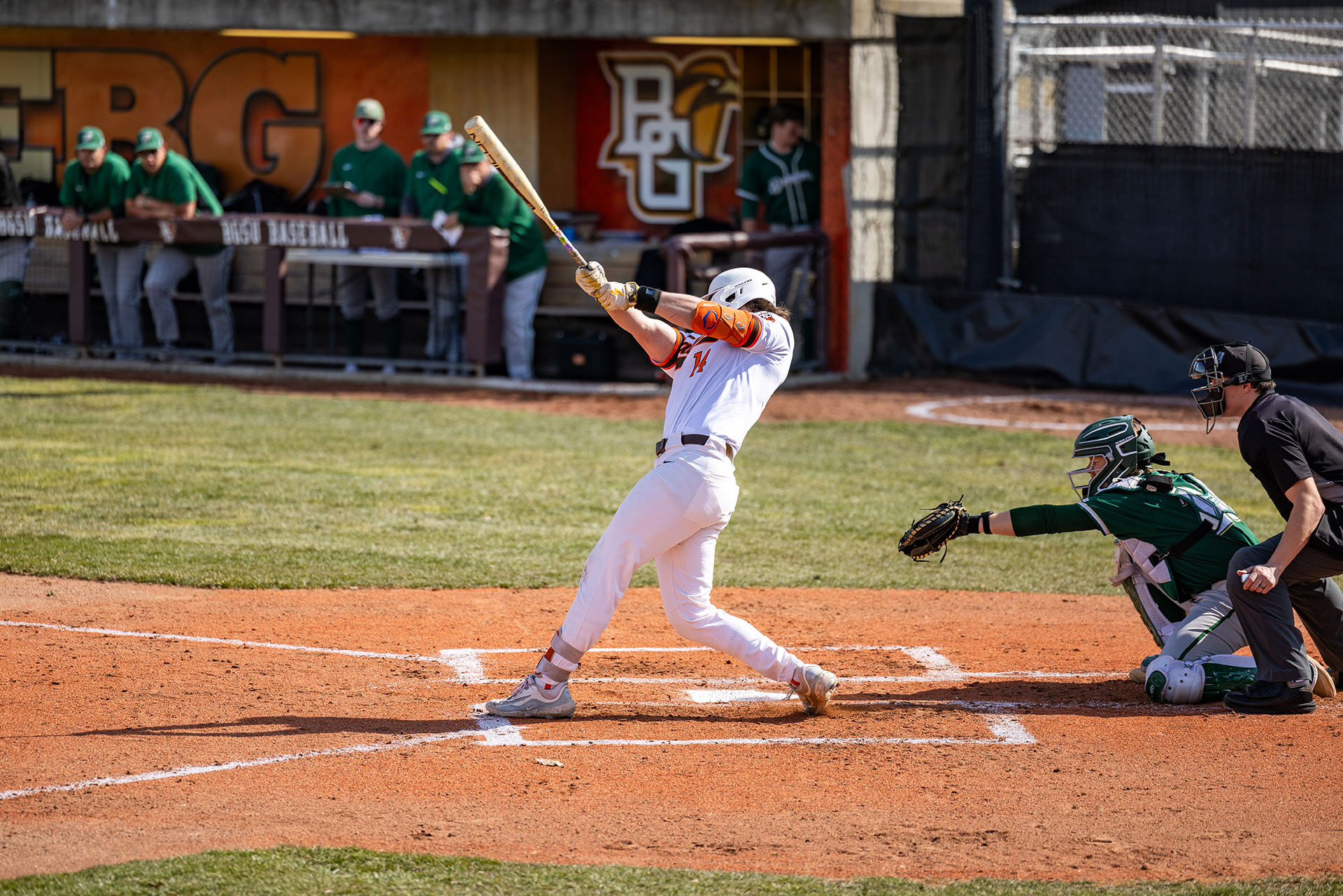 A person swinging a bat during a baseball game.