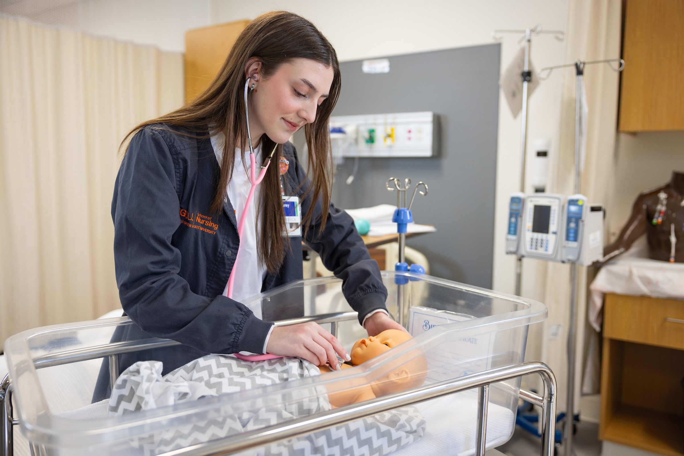 Audrey Simpson practicing an exam on an infant manikin