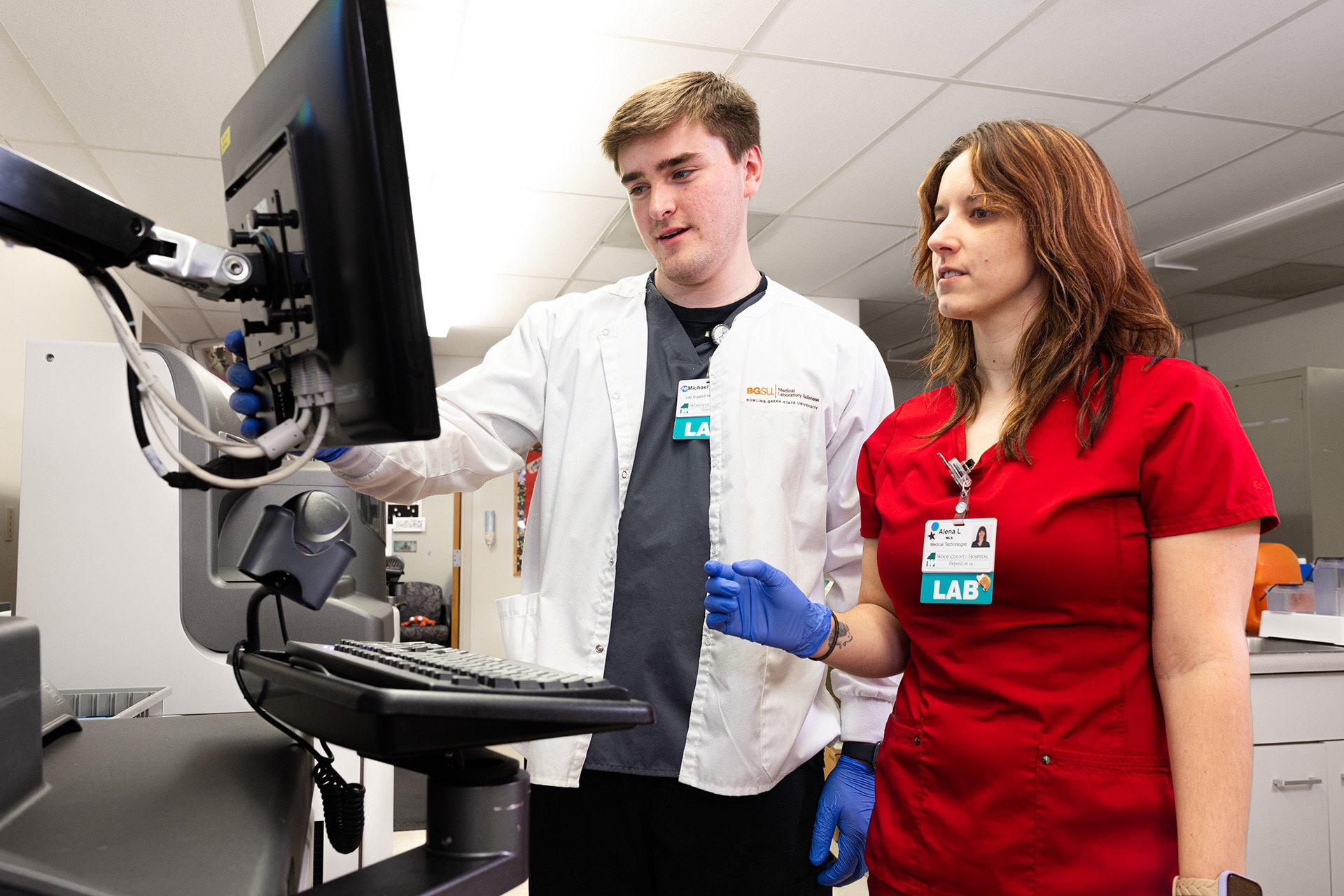 Two people work in a medical lab