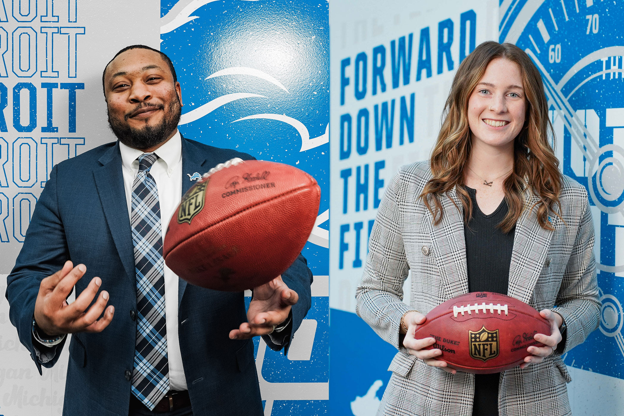 Two people pose with a football.